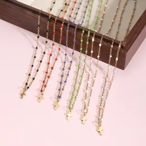 Fashionable electroplated stainless steel cross pendant necklace for women, simple and versatile, with oil-drop rice beads and a choker chain.