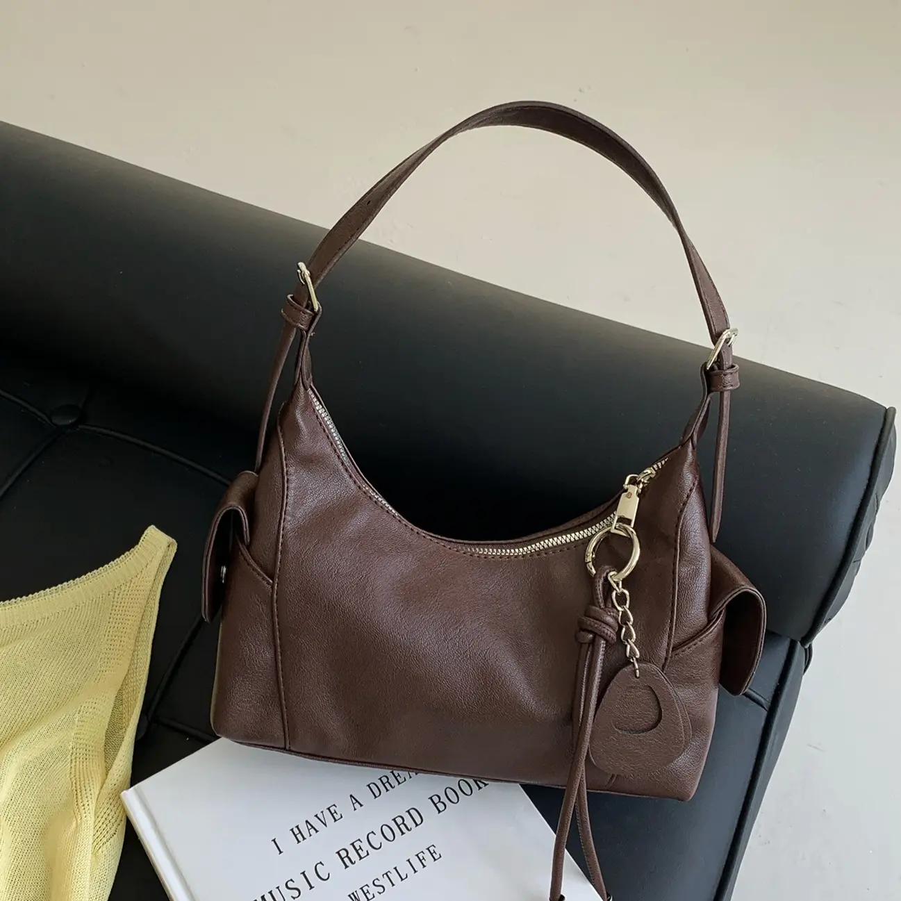 Soft everyday shoulder bag for women with sleek topstitching a small crossbody purse in brown or black a streetwear motorcycle style PU handbag with polyester lining and hidden zipper pocket perfect for daily commutes and casual outfits