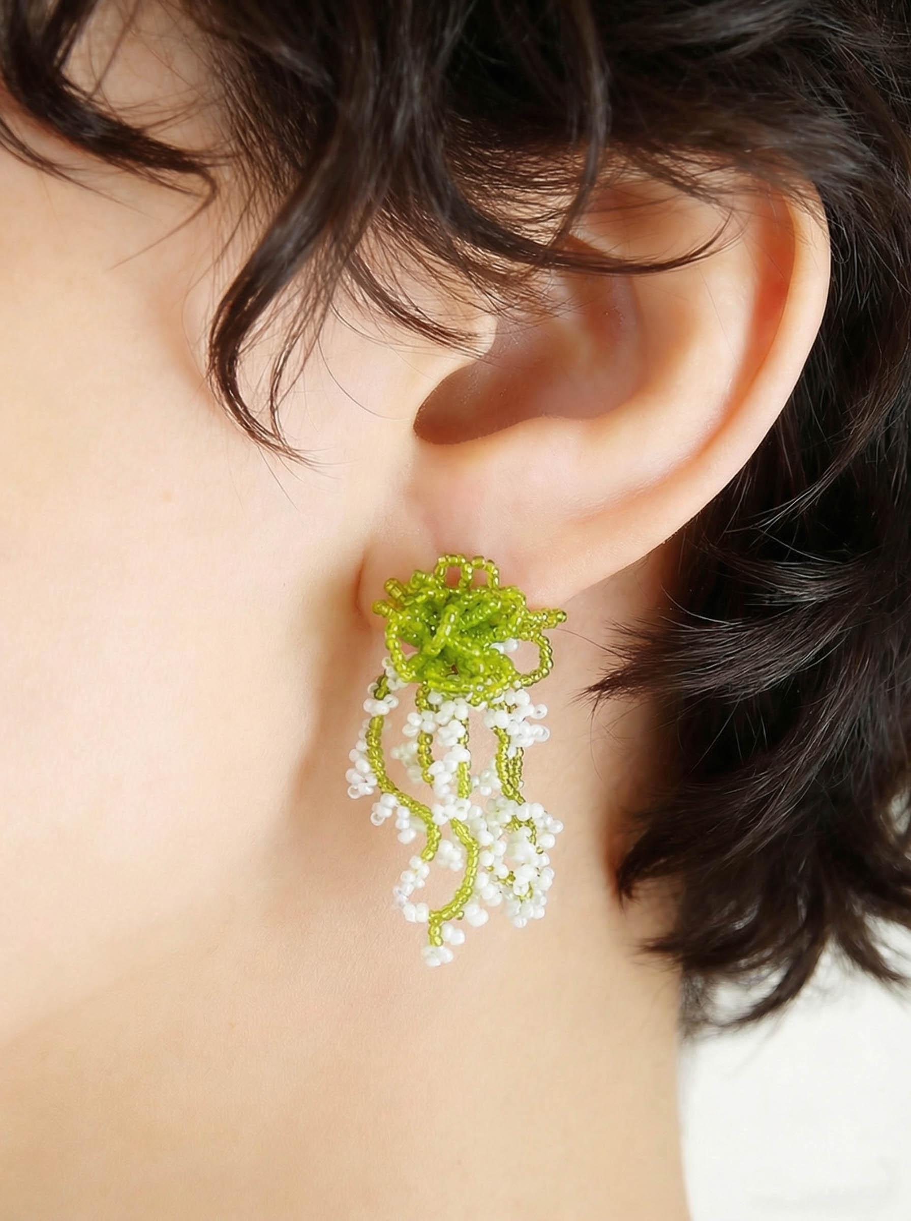 A pair of glass bead fringe earrings featuring a floral waterfall design, handcrafted earrings with a fresh, sweet style, perfect for a laid-back summer beach vacation look