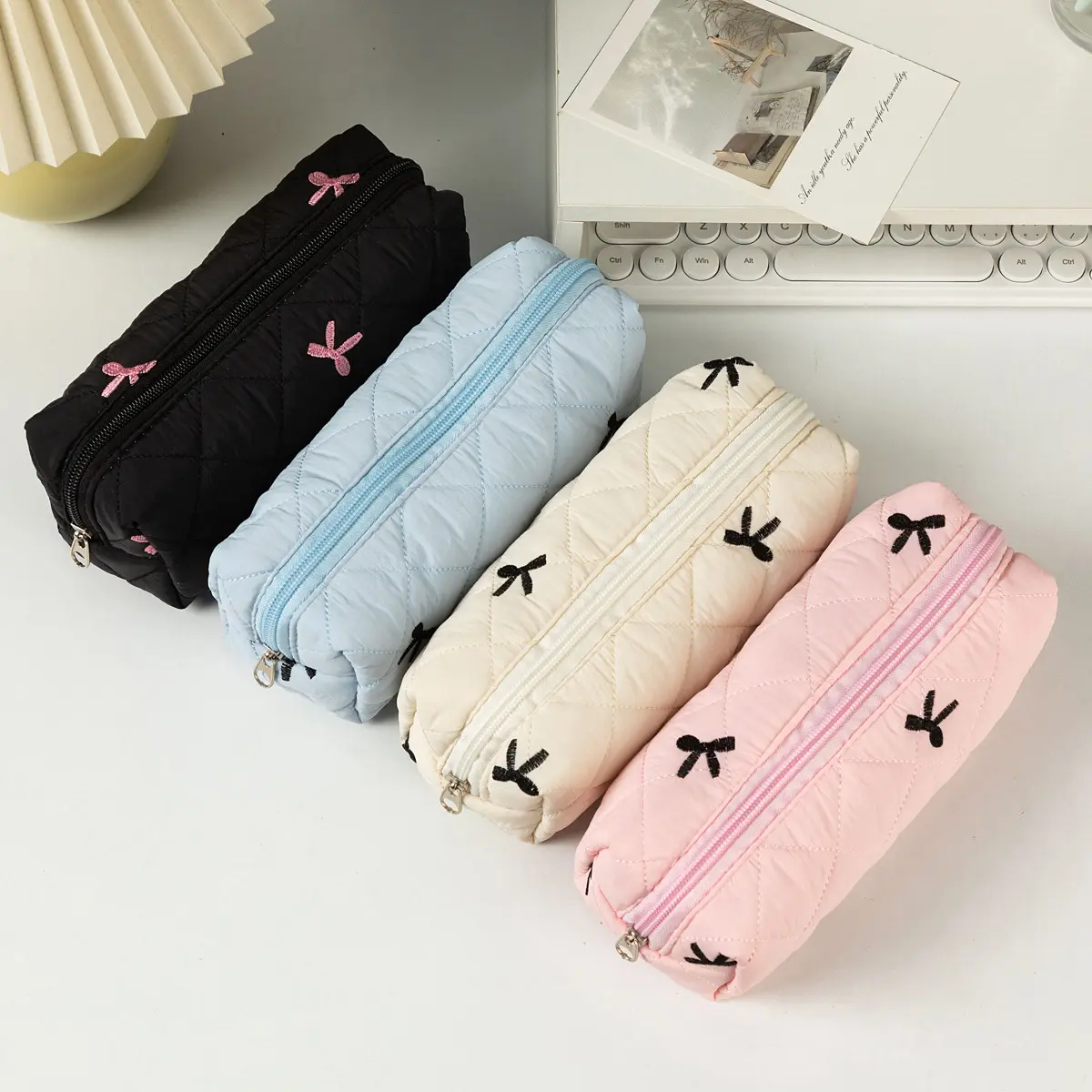 Quilted pencil case, cute bow-embroidered pen pouch, stylish padded stationery organizer, and high-capacity school supply pouch for girls.