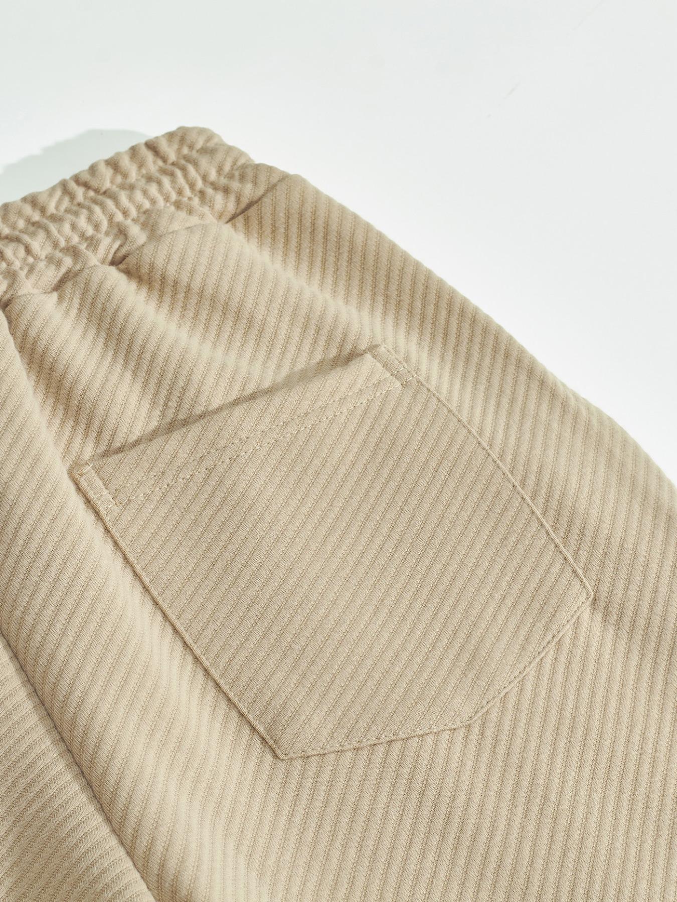 Men's two-piece casual suit outfit with a stand-up collar, long sleeves with a subtle texture, and long pants. The top has a single- button front with a pocket, suitable for daily outings, casual commuting, and light business casual occasions. Men's suit.