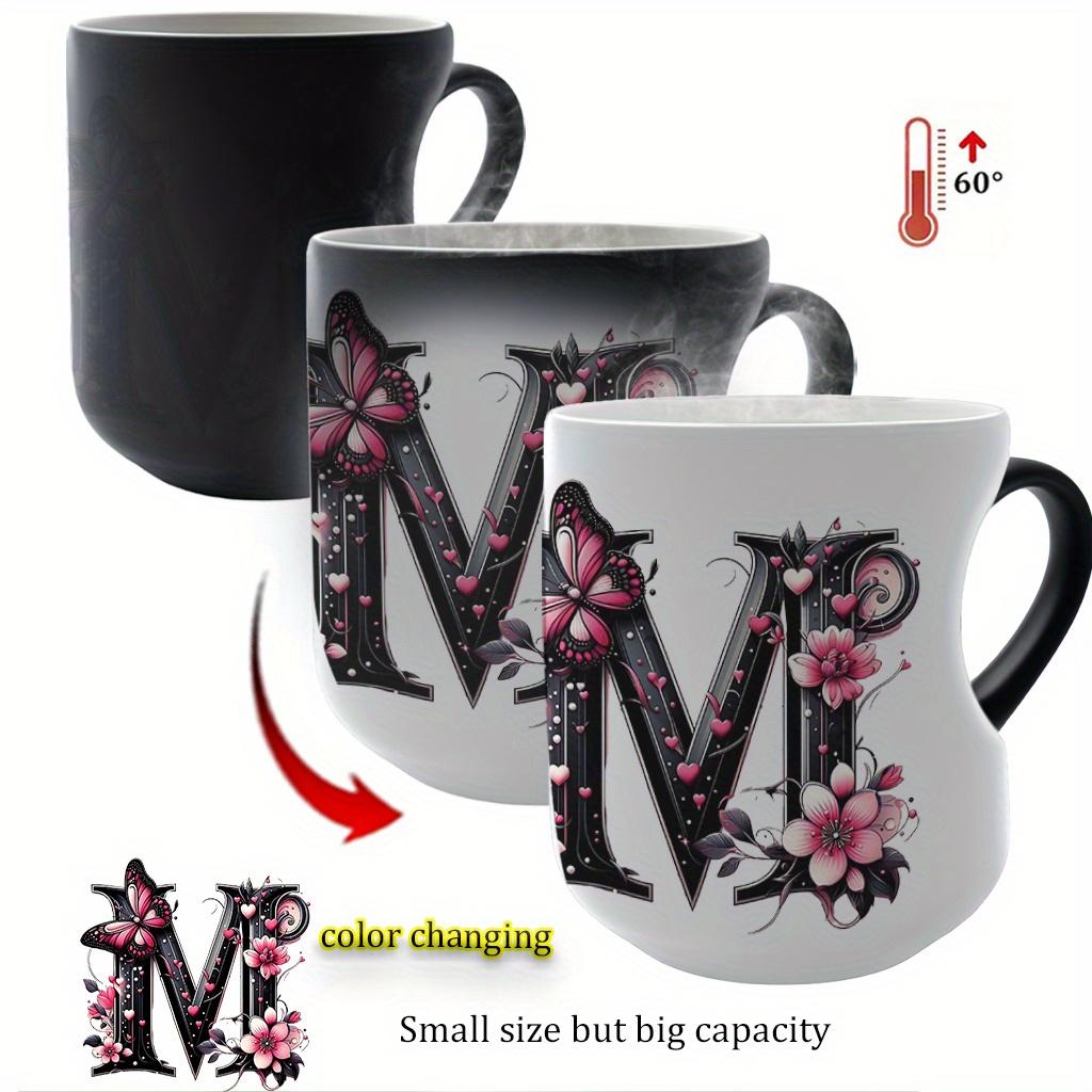 Heat-changing ceramic mug with pink butterfly and floral motif, heart-shaped handle, 11 oz/330 ml capacity. This color-changing thermos is perfect for hot and cold beverages.