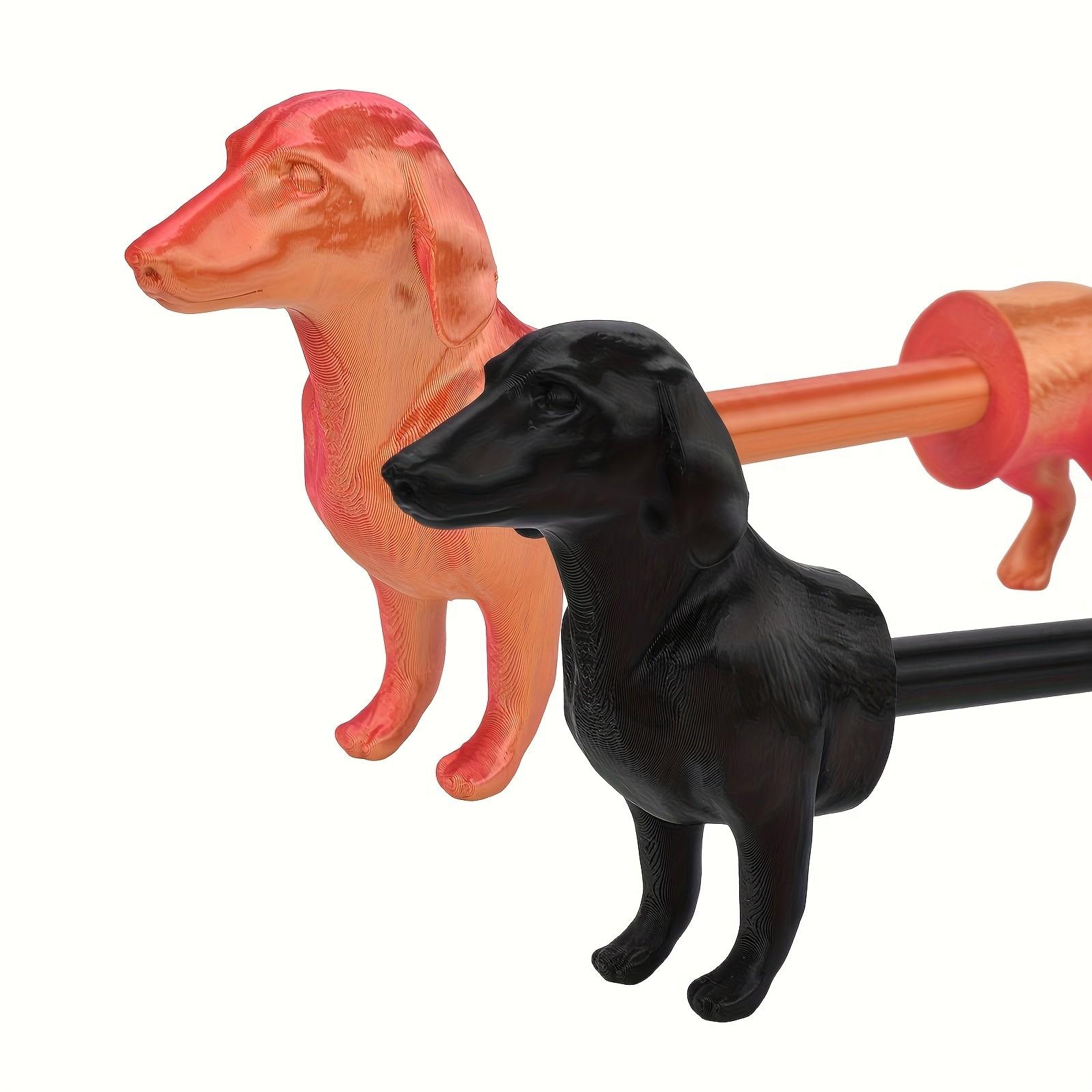 A humorous sausage dog-themed toilet paper holder - an independent black roll holder featuring a cute dog design, made of sturdy plastic and also suitable for kitchen paper towels