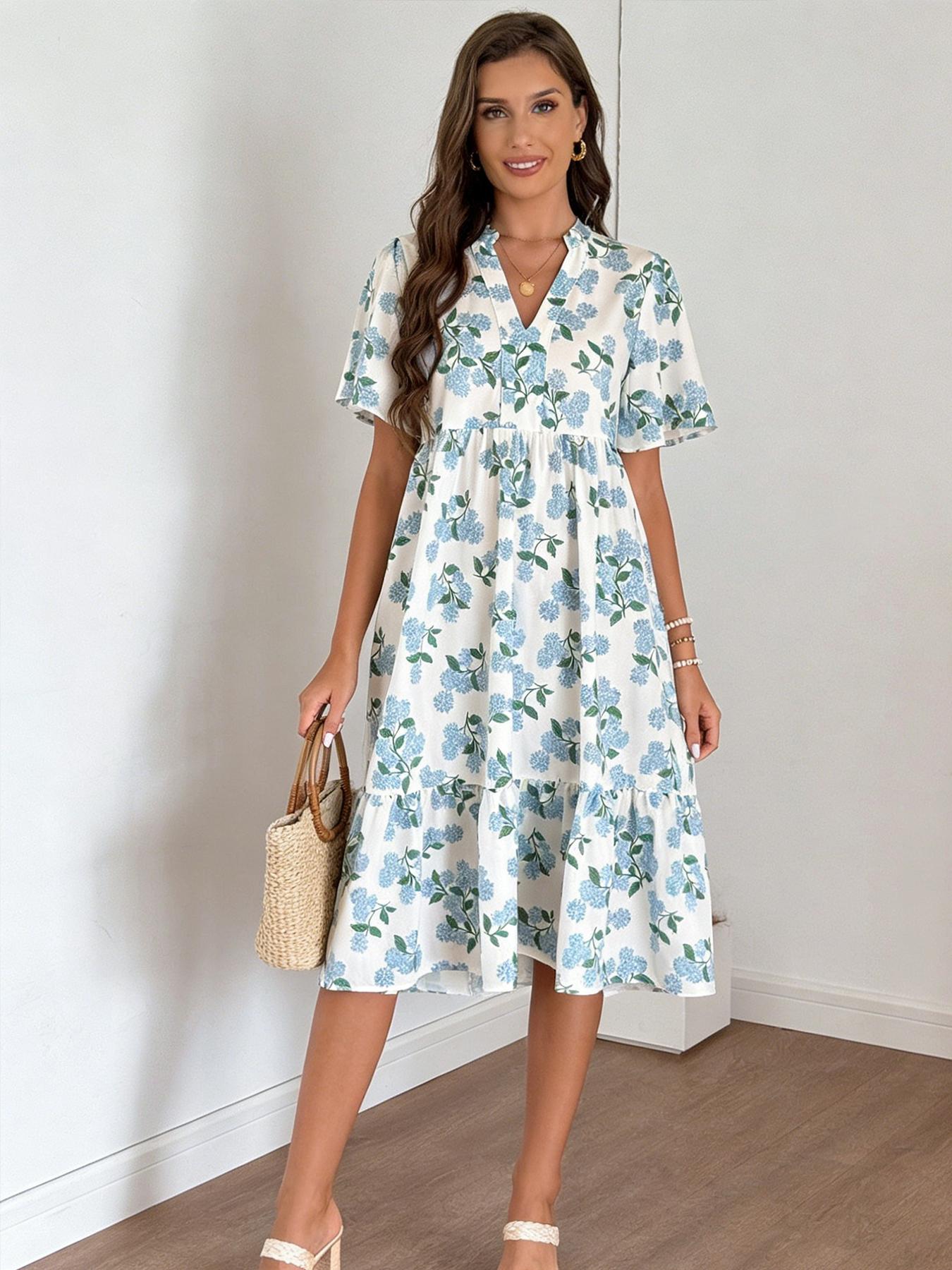 A women's V-neck short-sleeve midi dress with a layered skirt, featuring white fabric with A women's V-neck short-sleeve midi dress with a layered skirt, featuring white fabric with