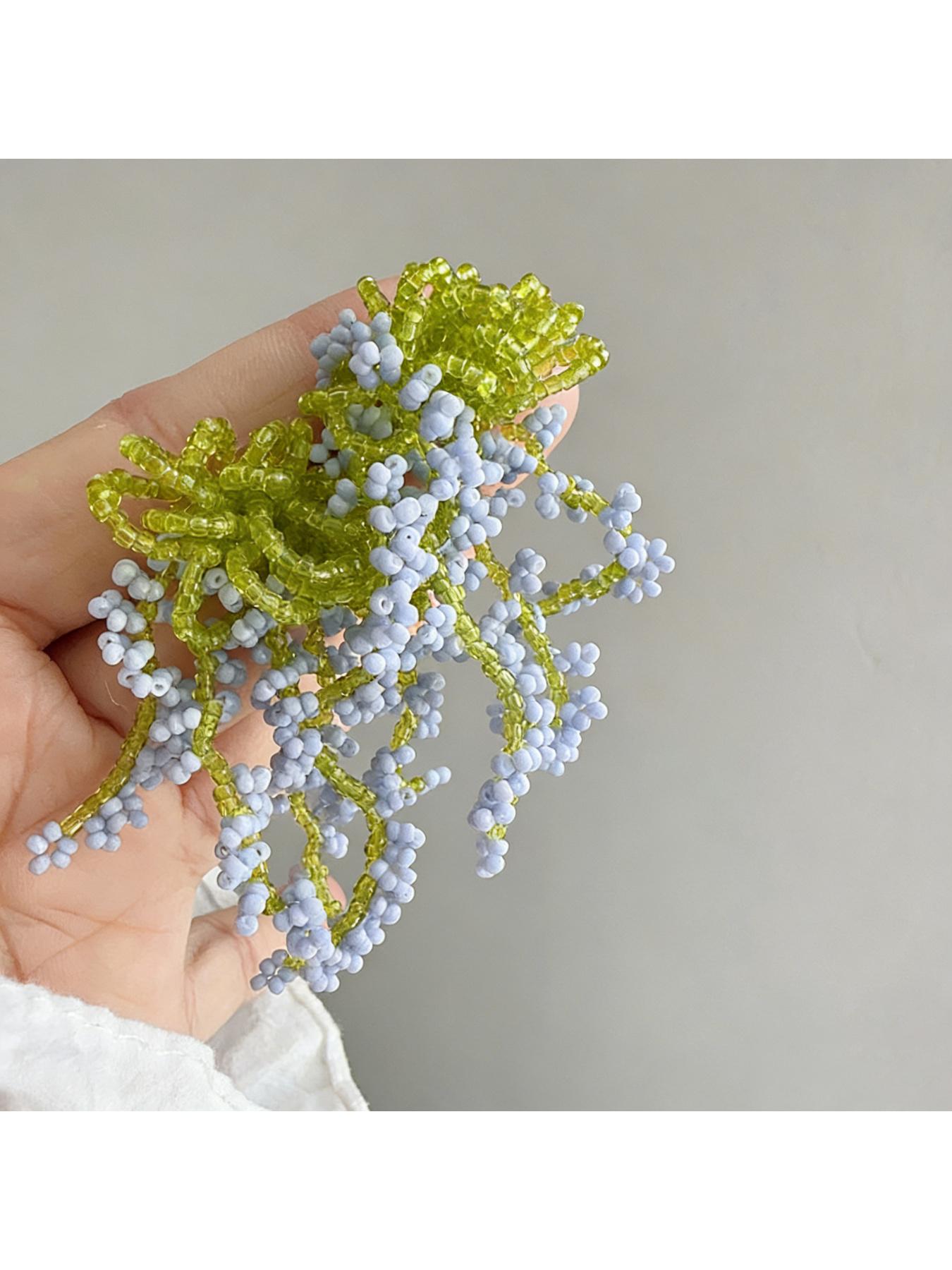 A pair of glass bead fringe earrings featuring a floral waterfall design, handcrafted earrings with a fresh, sweet style, perfect for a laid-back summer beach vacation look