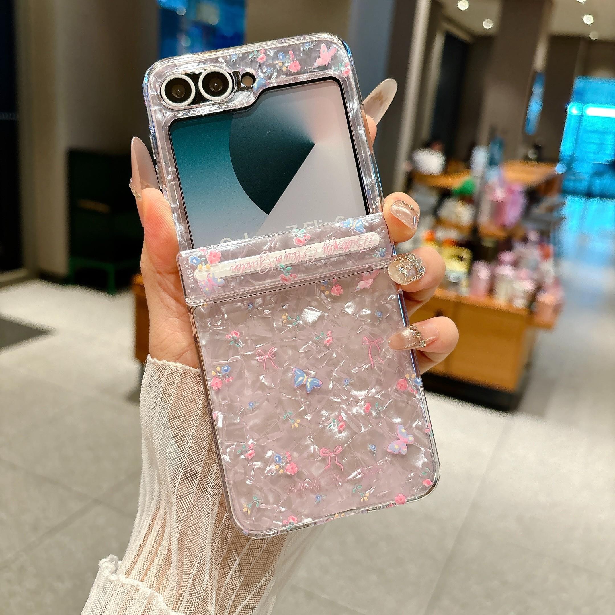 Fresh Floral & Magnetic Snap Shell Pattern Phone Case with optional wrist strap for easy carrying. for Samsung Galaxy Z Flip 5/6/7FE/7. Features a refreshing style, fashionable protection, and unique design perfect for daily use. Protective outer shell.