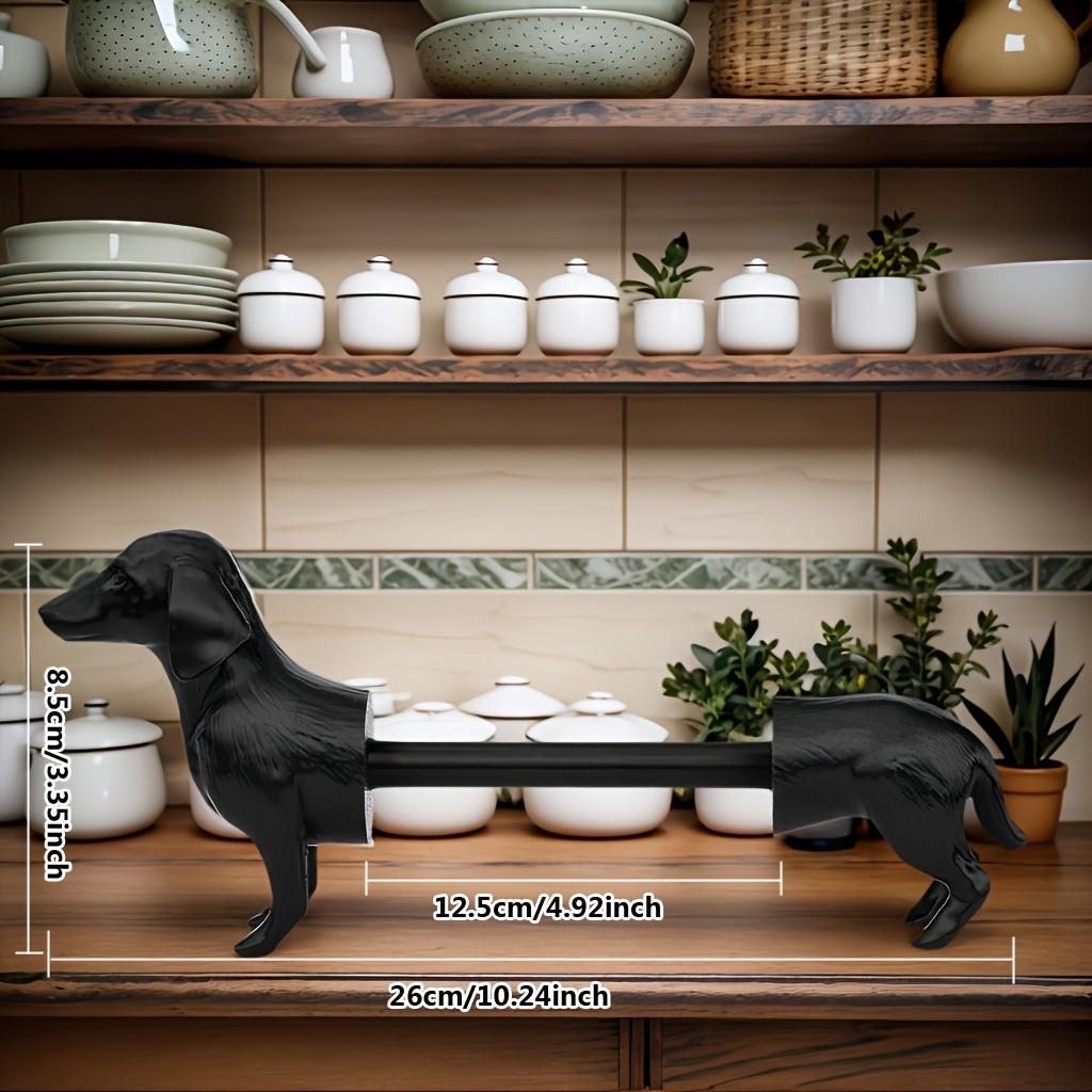A humorous sausage dog-themed toilet paper holder - an independent black roll holder featuring a cute dog design, made of sturdy plastic and also suitable for kitchen paper towels