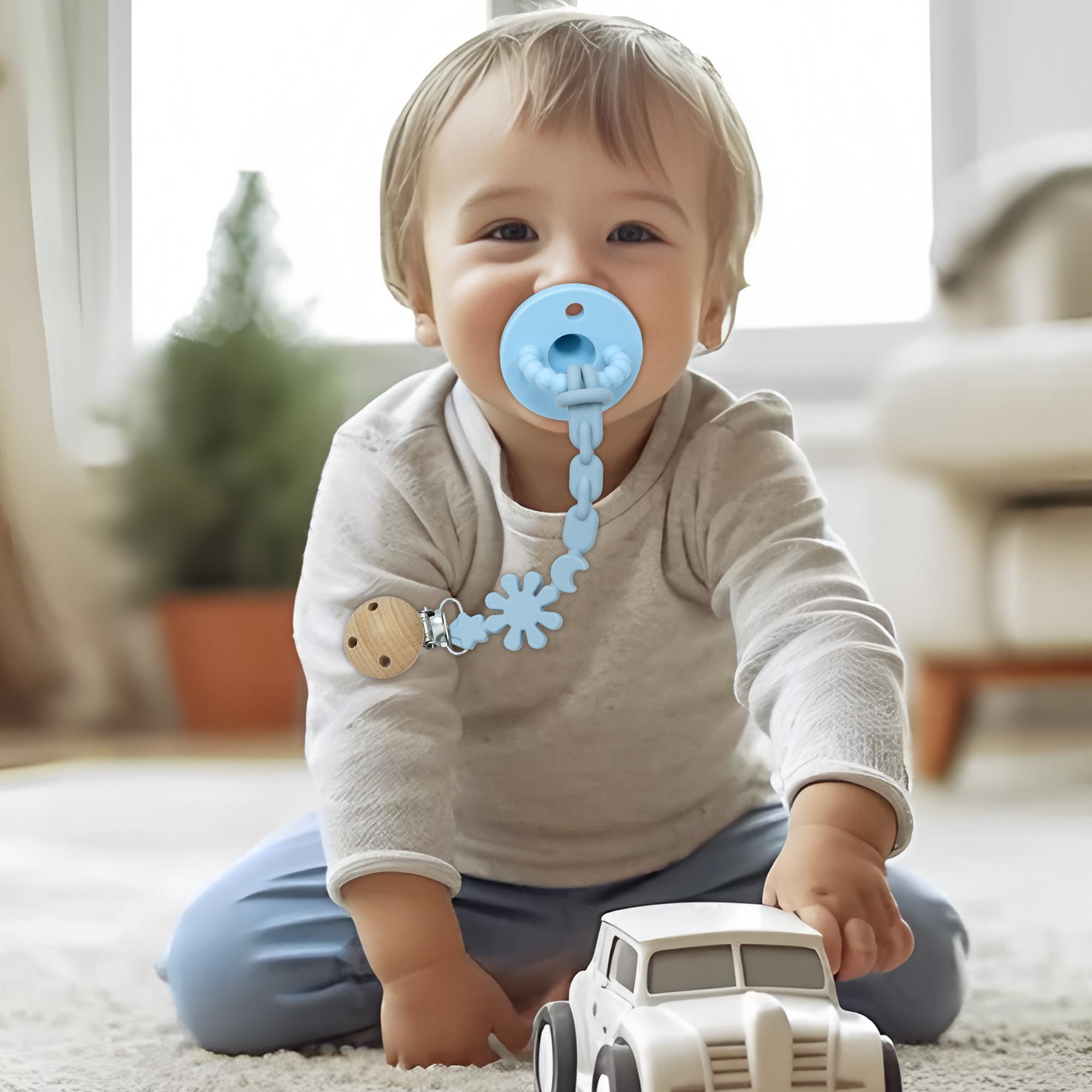 This convenient pacifier chain features a clip to prevent it from ...