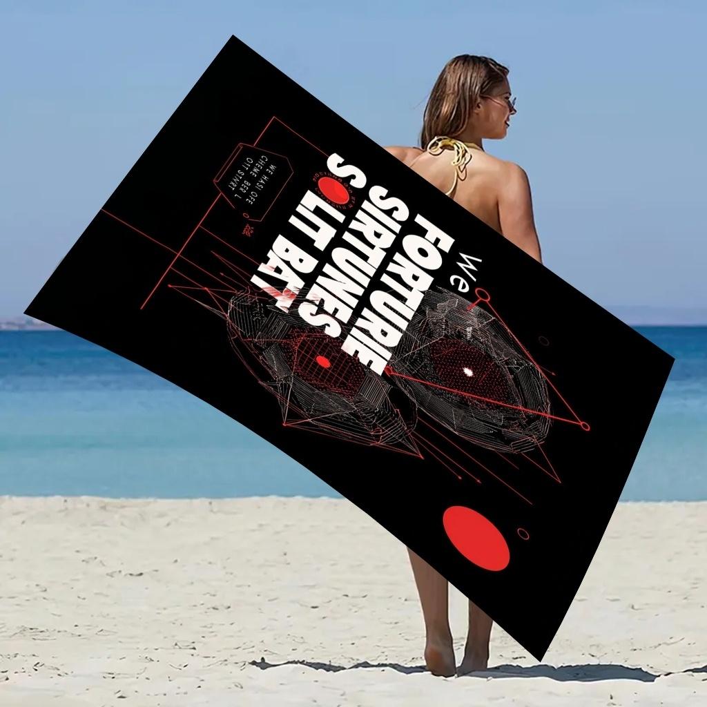 Black background with red geometric patterns and white text; beach towel/beach towel multi-functional use. Absorbent towel