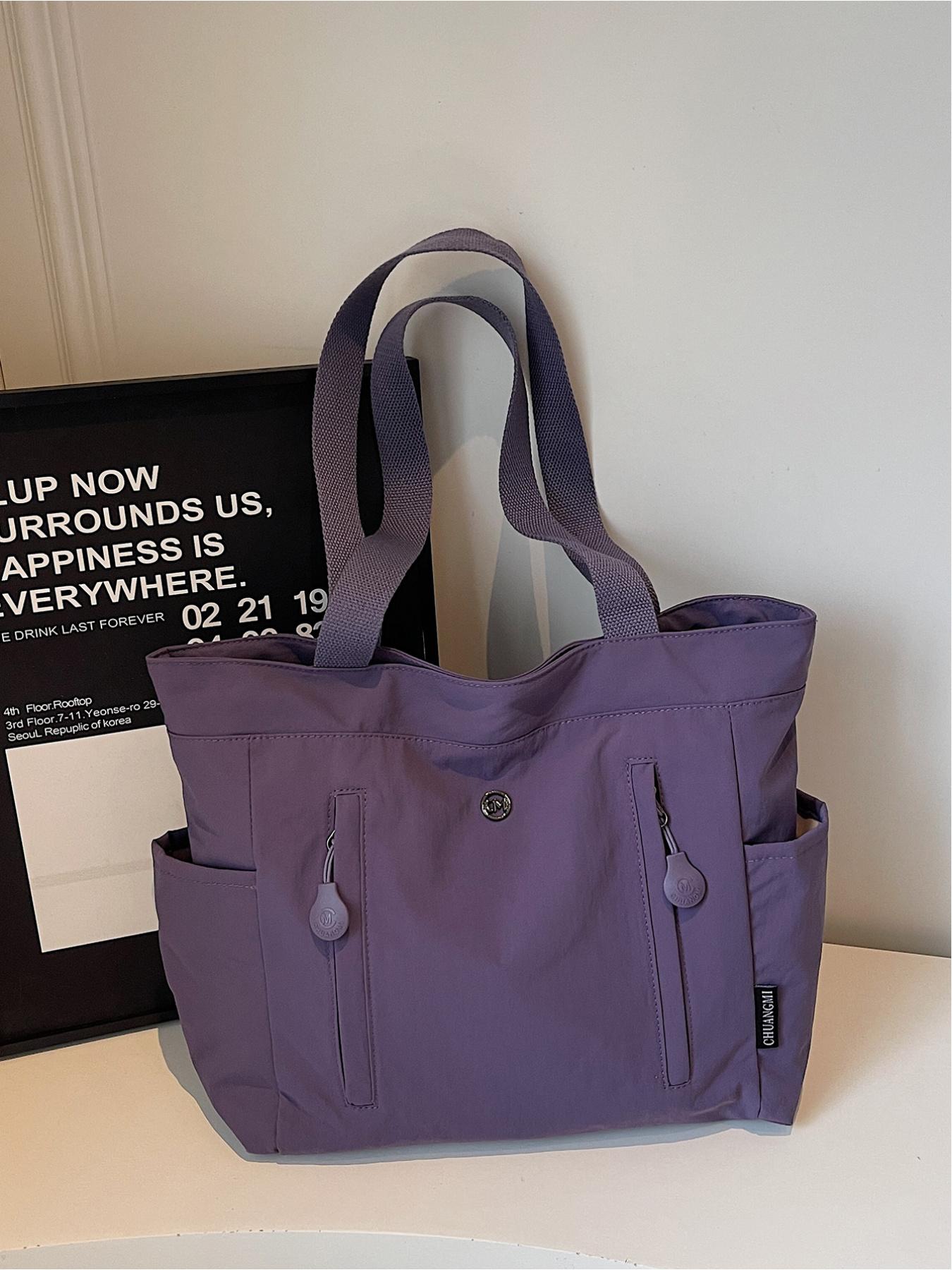 The large capacity soft commuter tote bag, is lightweight, spacious, suitable for daily use. It is a neutral waterproof nylon shoulder bag with a spacious interior suitable for 15 inch laptops, multiple side pockets, and a comfortable adjustab