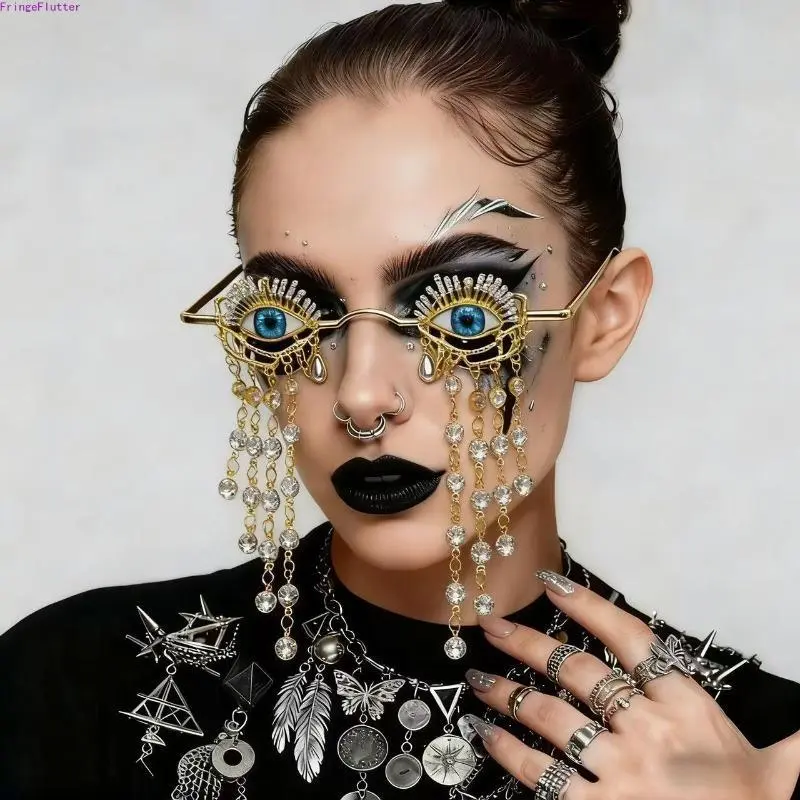 Gothic-style witch sunglasses featuring small metal frames, rhinestone-embellished eyeball accents, and dangling tassels—distinctive eyewear for dark-themed Halloween parties and stage performances.