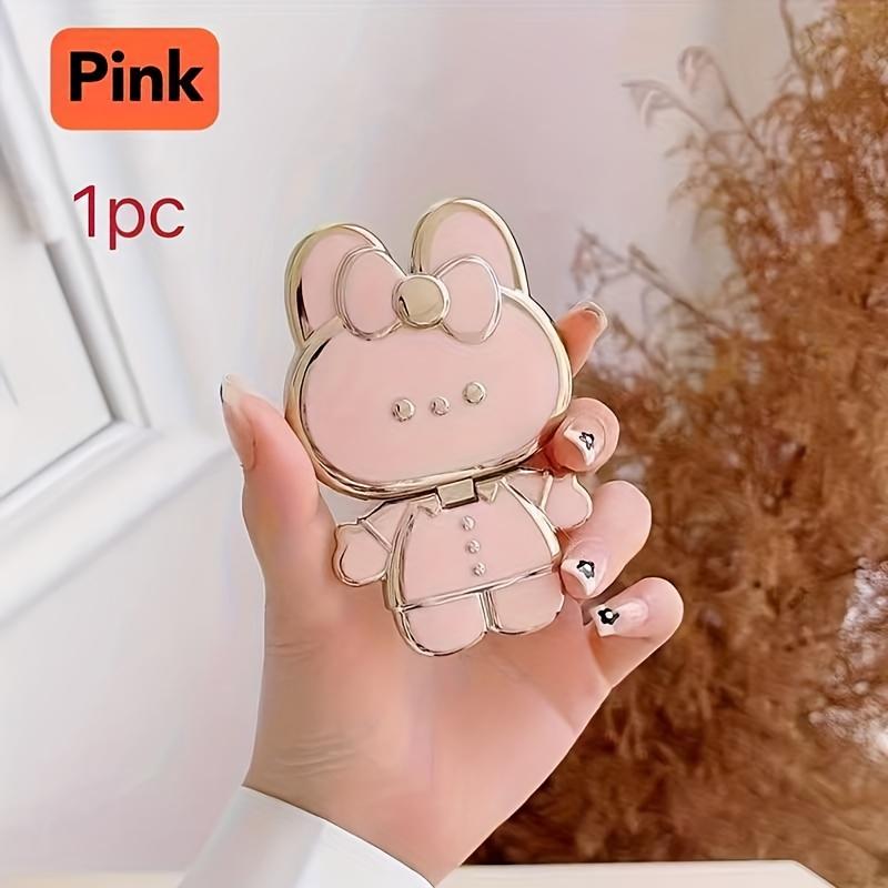 New rabbit-shaped adhesive phone stand with makeup mirror is suitable for iPhone, Samsung, Xiaomi phones, and various other phones. The rabbit phone case desktop stand is a hollow-out lazy stand