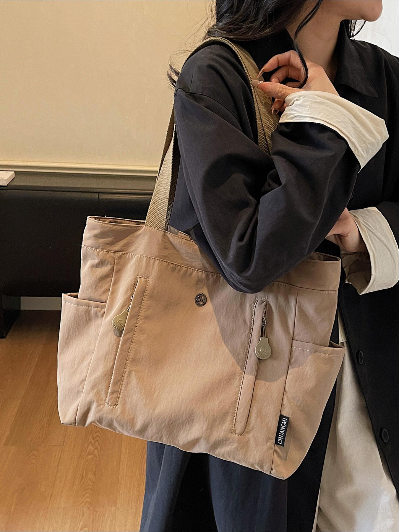 The large capacity soft commuter tote bag, is lightweight, spacious, suitable for daily use. It is a neutral waterproof nylon shoulder bag with a spacious interior suitable for 15 inch laptops, multiple side pockets, and a comfortable adjustab