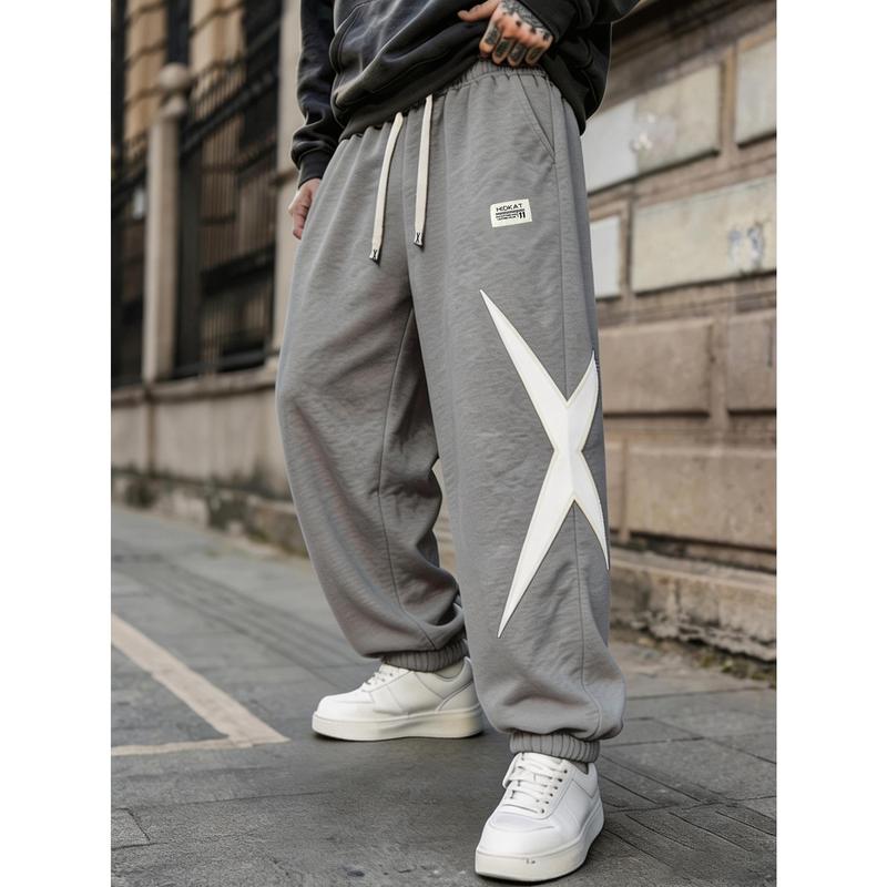 Men's work pants, black and white color block jogging pants, elastic waist with white long drawstring, irregular white stitching, deep side pockets, loose lantern pants, suitable for hip-hop streetwear and daily clothing