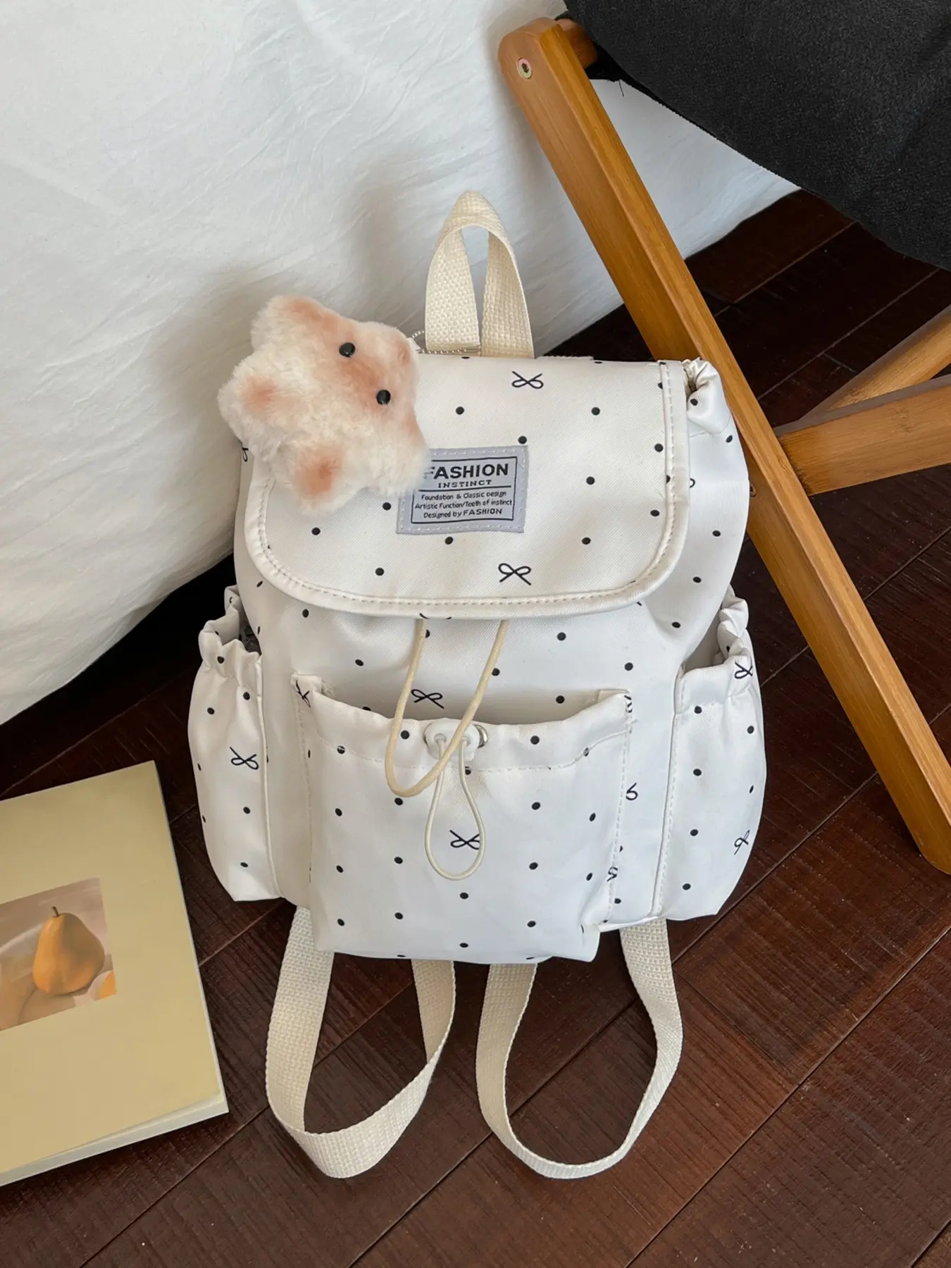 Korean-style gentle polka dot bow backpack, with fresh printed fabric, drawstring flap design, paired with a plush toy charm, a lightweight backpack perfect for daily school, work, travel, and shopping.