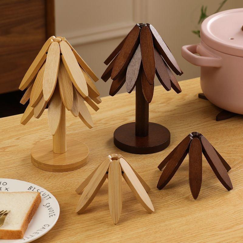 2026 Natural Tree Trivet Set - Christmas Tree Design! This heat - resistant set includes 4 walnut - wood trivets and 1 stand, stored like a Christmas tree. A foldable kitchen decor art, perfect for pots, bowls, coffee mugs, teapots and hot pots.