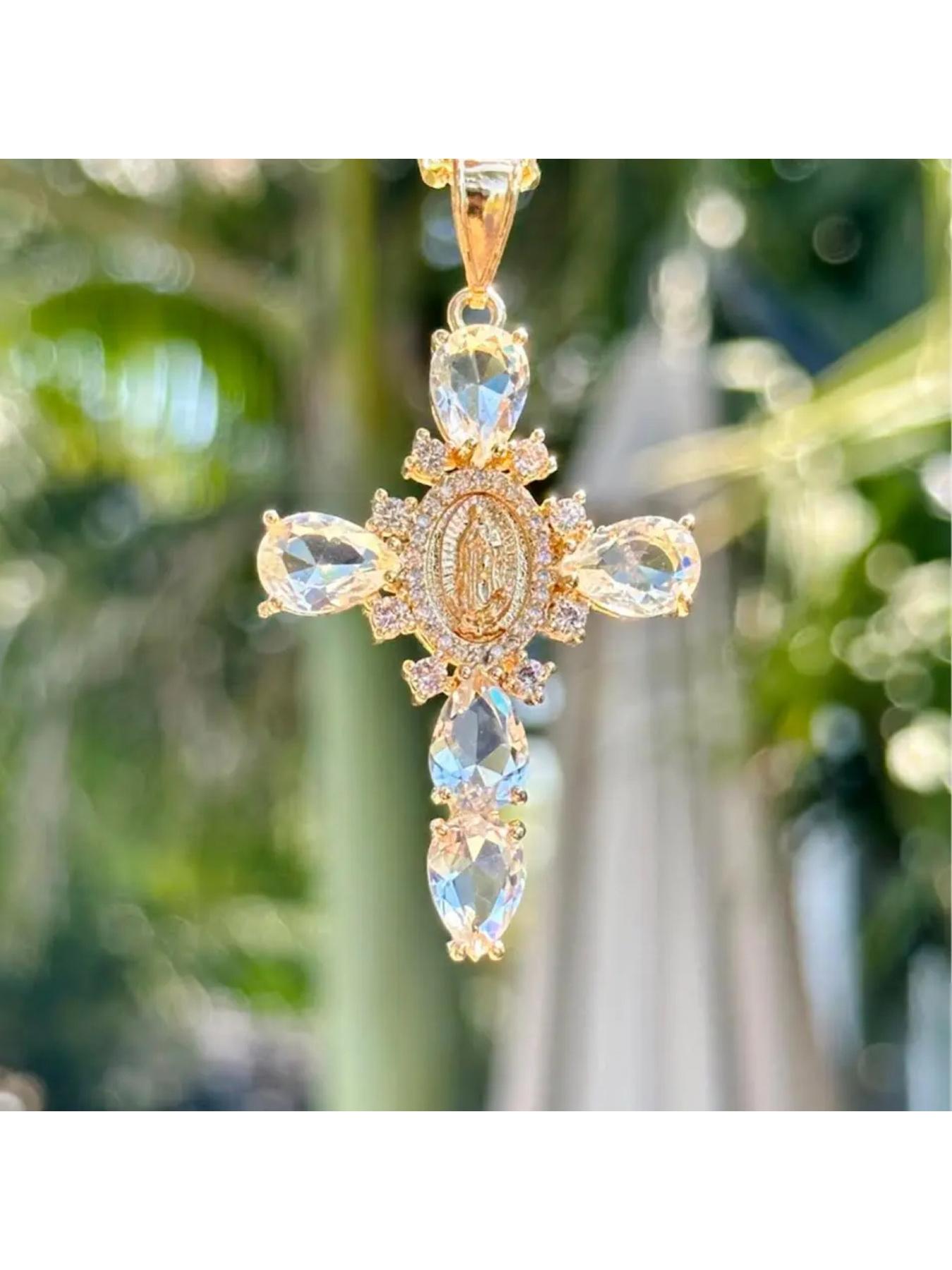Our Lady of Guadalupe Cross Pendant NecklaceTeardrop Crystal Religious Jewelry. A golden cross adorned with a delicate image of the Virgin Mary, surrounded by sparkling teardrop-shaped crystals, available in purple/pink/transparent colors