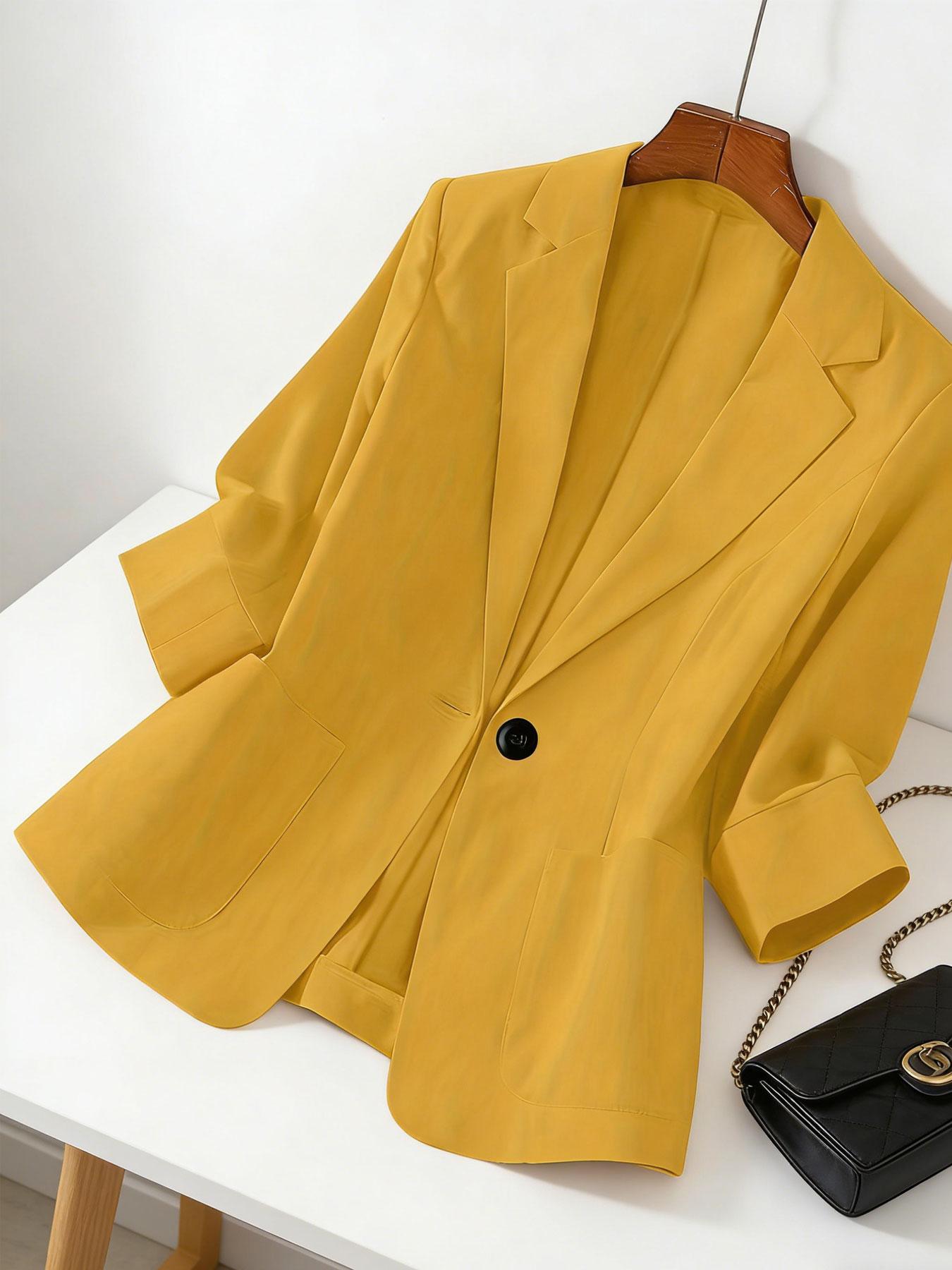 A women's solid color lapel single-breasted single-button mid-length sleeve double-pocket stylish blazer, suitable for spring and summer, appropriate for the workplace and daily wear.