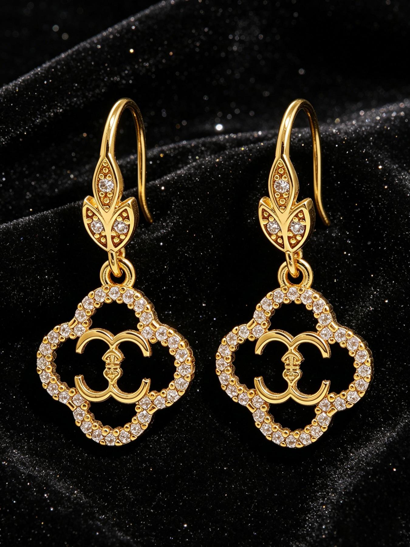 A pair of openwork flower earrings, delicate four-leaf clover earrings, and luxurious copper earrings inlaid with zircon