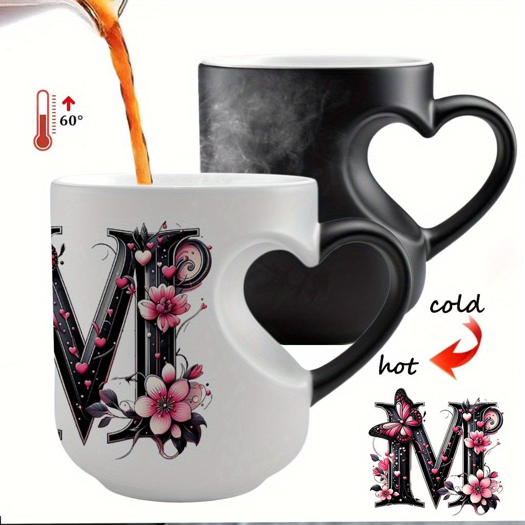 Heat-changing ceramic mug with pink butterfly and floral motif, heart-shaped handle, 11 oz/330 ml capacity. This color-changing thermos is perfect for hot and cold beverages.
