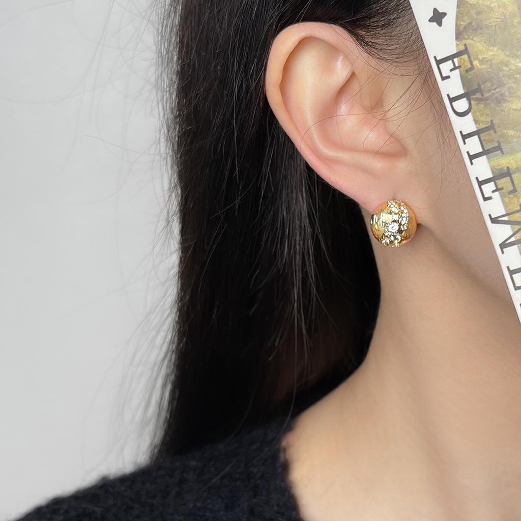 A pair of vintage style zirconia brushed round earrings, distinctive, luxurious, and sophisticated studs that are a versatile classic.