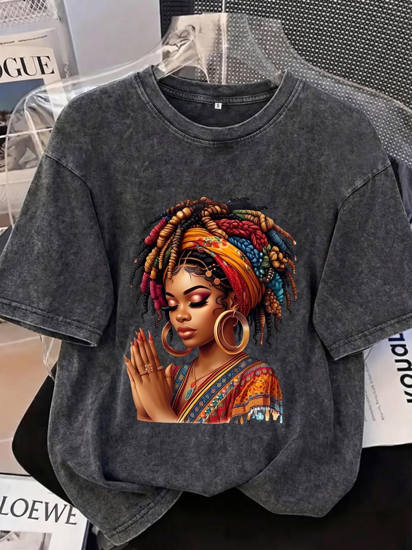 Distressed T-shirt featuring a colorful portrait print of an African woman; relaxed American style with soft, vintage-wash cotton fabric—perfect for pairing with denim shorts or wide-leg trousers for a casual street-style look Streetwear