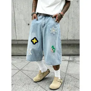 Men’s 3/4 loose denim shorts, hip-hop street style, chenille patch appliqué, wide-leg denim shorts, vintage black wash, over-the-knee length, casual skate shorts, unisex denim apparel.