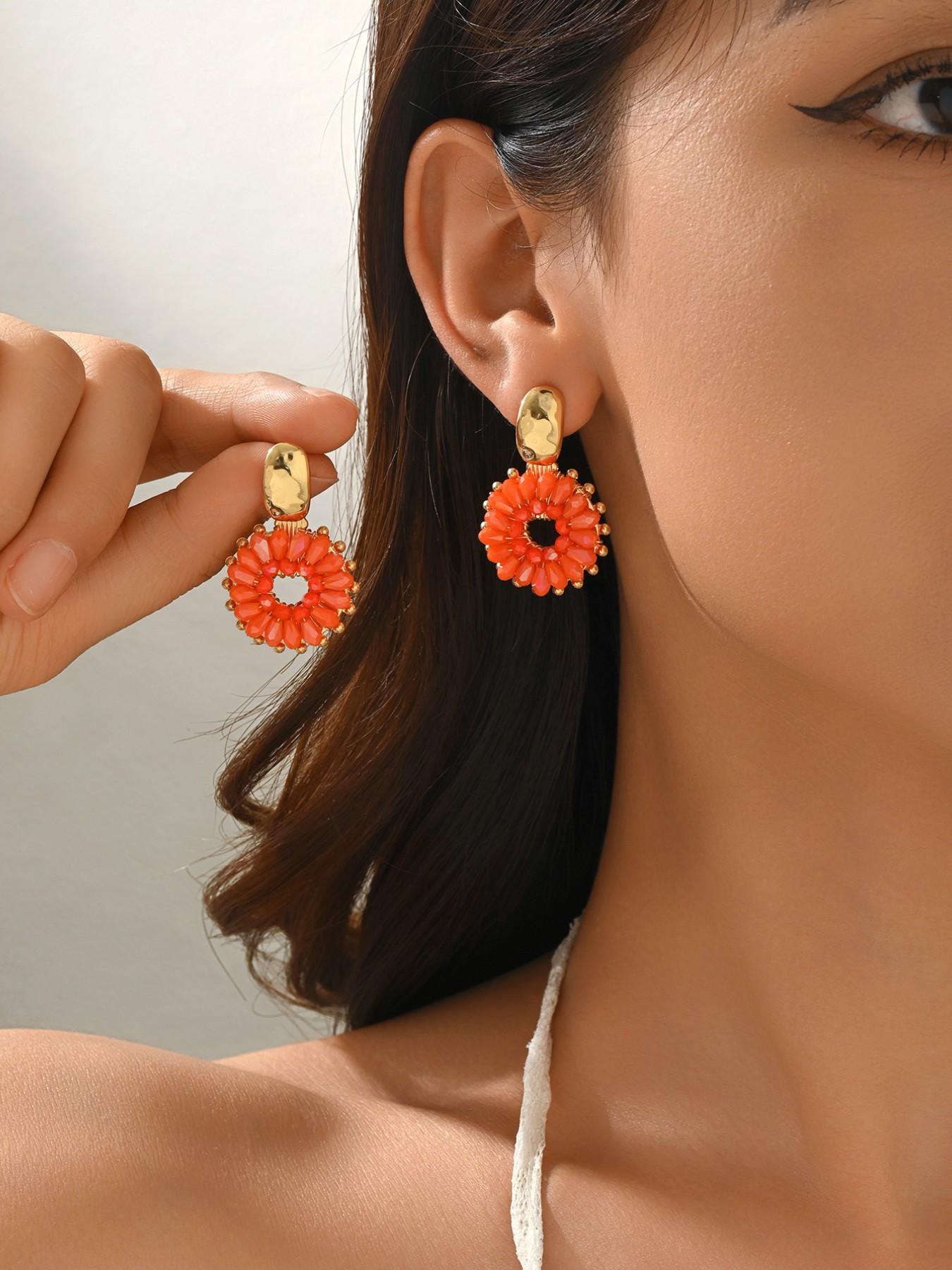 A pair of handcrafted, beaded dangle earrings featuring a chic Bohemian resort style. These round earrings exude an elegant, refined, and understated aesthetic with a premium feel, available in a variety of colors. for women to wear on any occasio