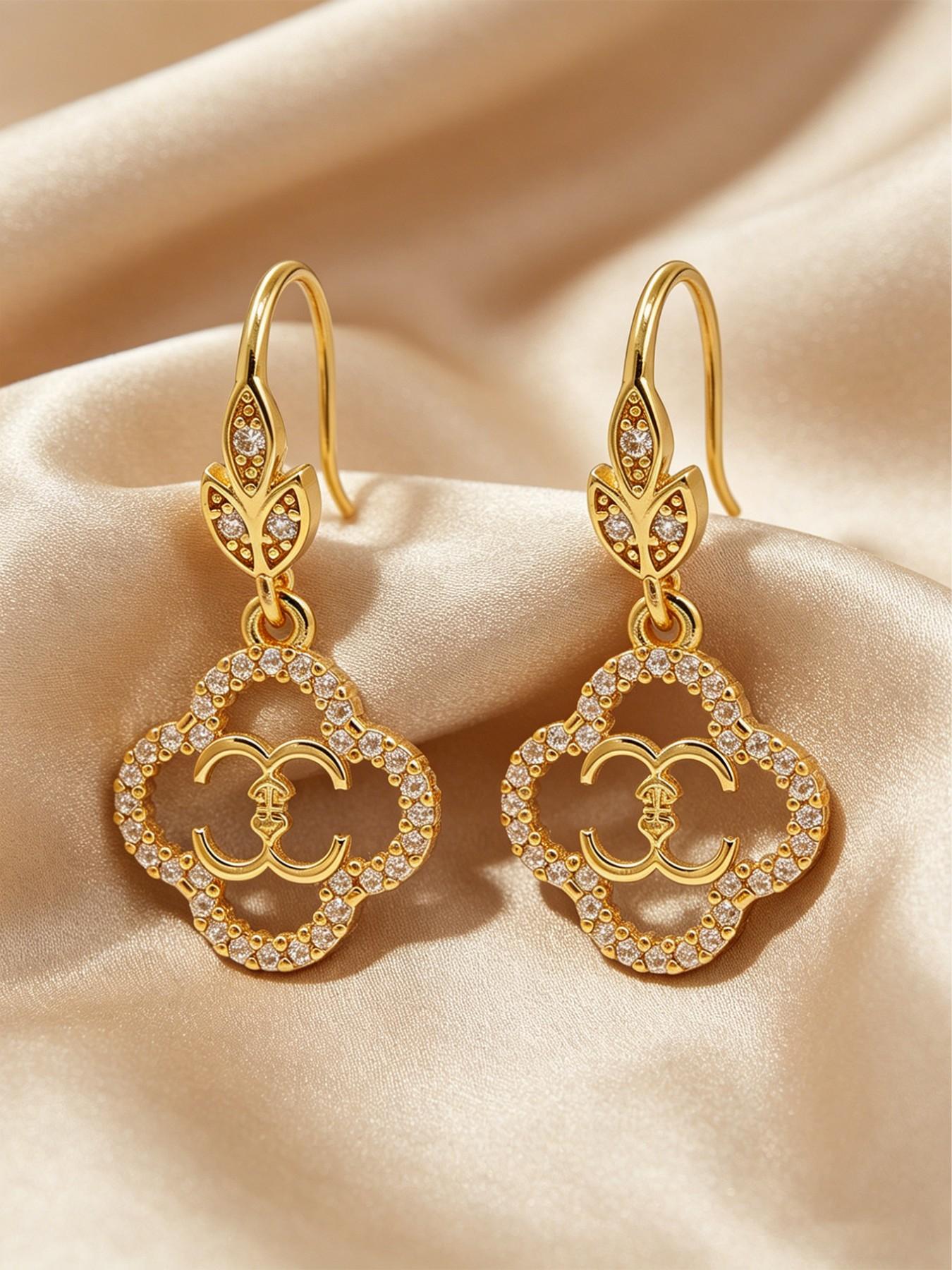 A pair of openwork flower earrings, delicate four-leaf clover earrings, and luxurious copper earrings inlaid with zircon