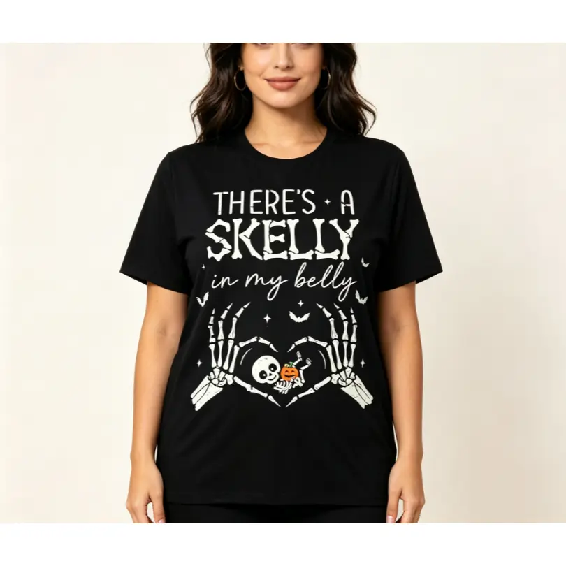 There's a Skelly in My Belly Pregnancy Halloween Graphic Tee – Black Tee With High-Quality Printed Design of Skeleton Hands Holding Baby Skull with Pumpkin, Maternity Halloween Aesthetic, 100% Cotton, Perfect Gift For Expecting Mothers & Halloween Lovers,