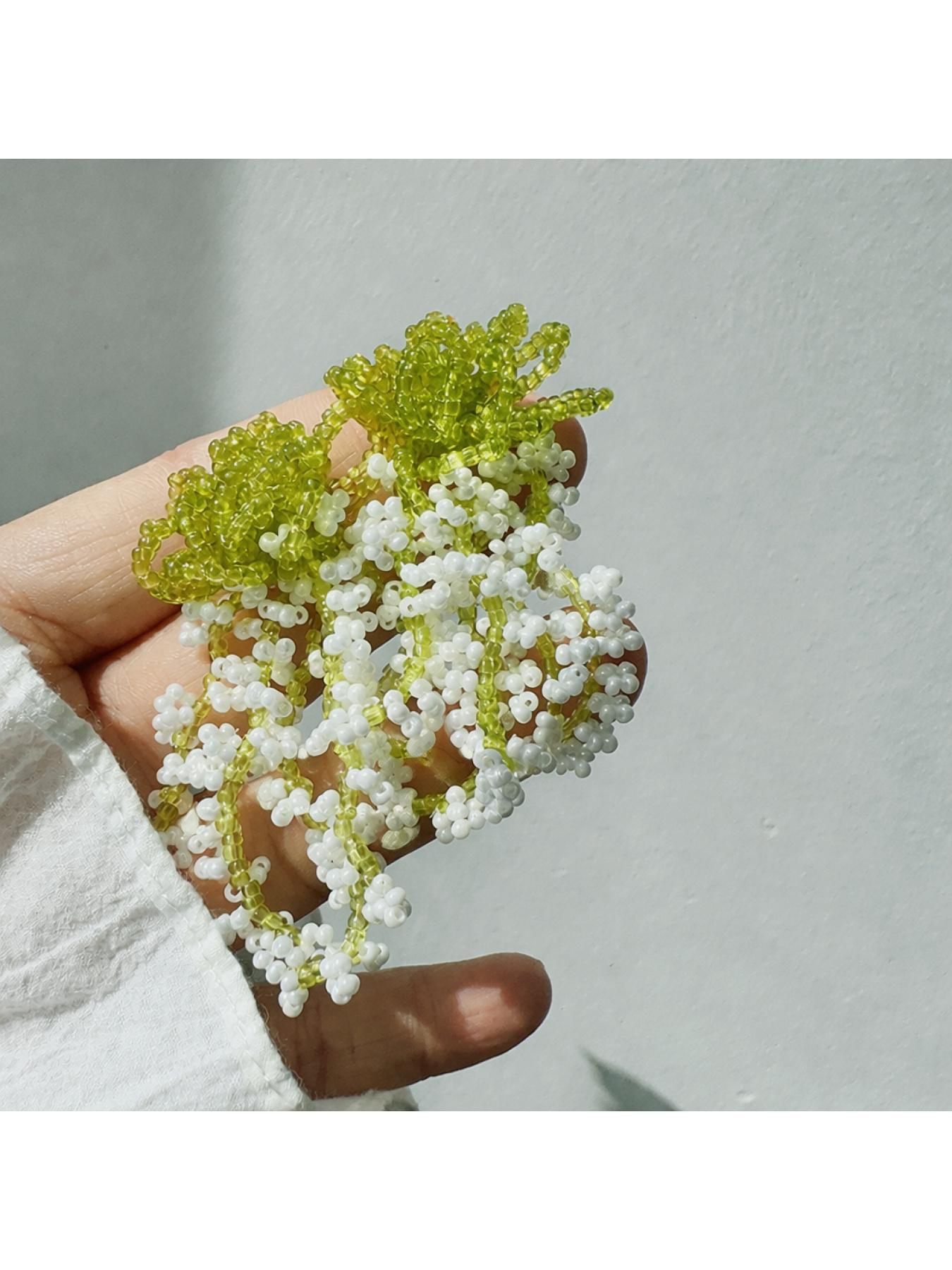 A pair of glass bead fringe earrings featuring a floral waterfall design, handcrafted earrings with a fresh, sweet style, perfect for a laid-back summer beach vacation look