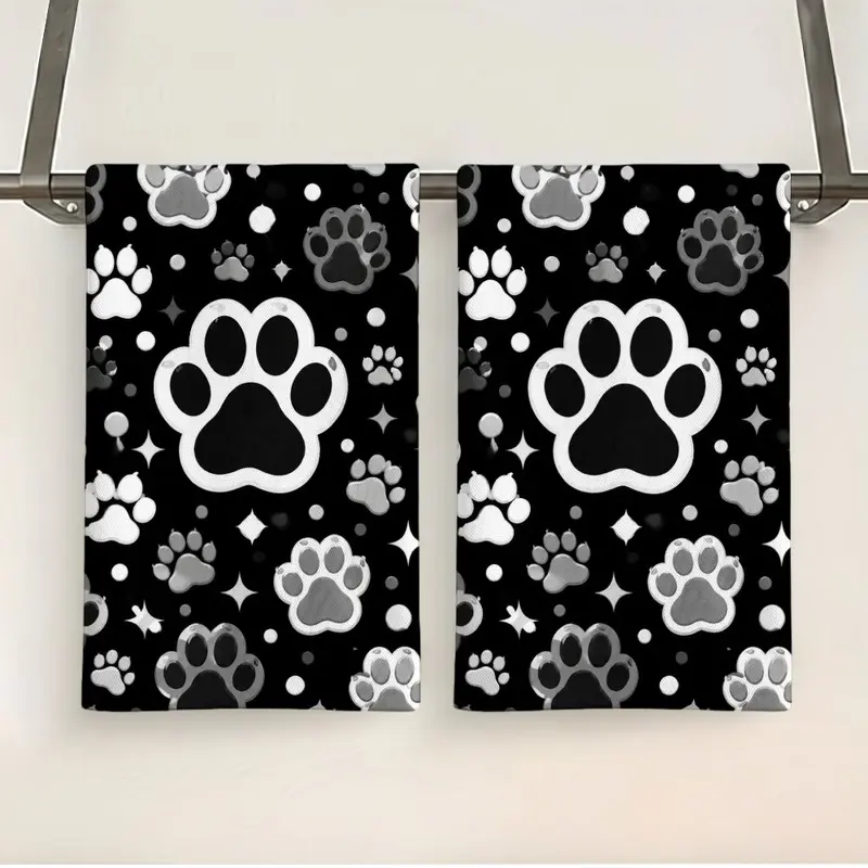 Monochromatic Animal Paw Print Tea Towel Set (16 x 24 inches) - Black towels featuring white and gray paw prints and sparkling star accents; a stylish Gothic-style, pet-themed gift for cat and dog lovers.