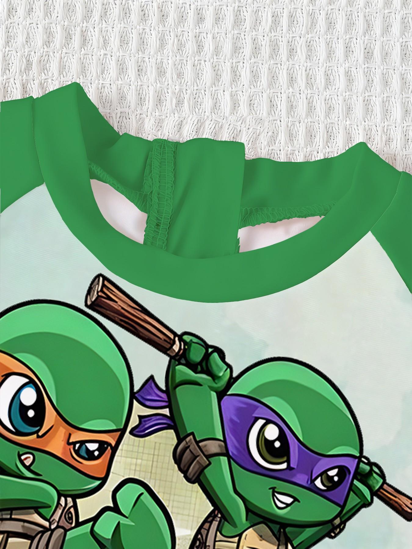 Boys' one-piece swimsuit "Chibi Ninja Turtles Team Edition" features all-over print of the four Chibi Ninja Turtles plus raglan green sleeves, cute and cool with sun protection, eye-catching for summer water play / beach vacations