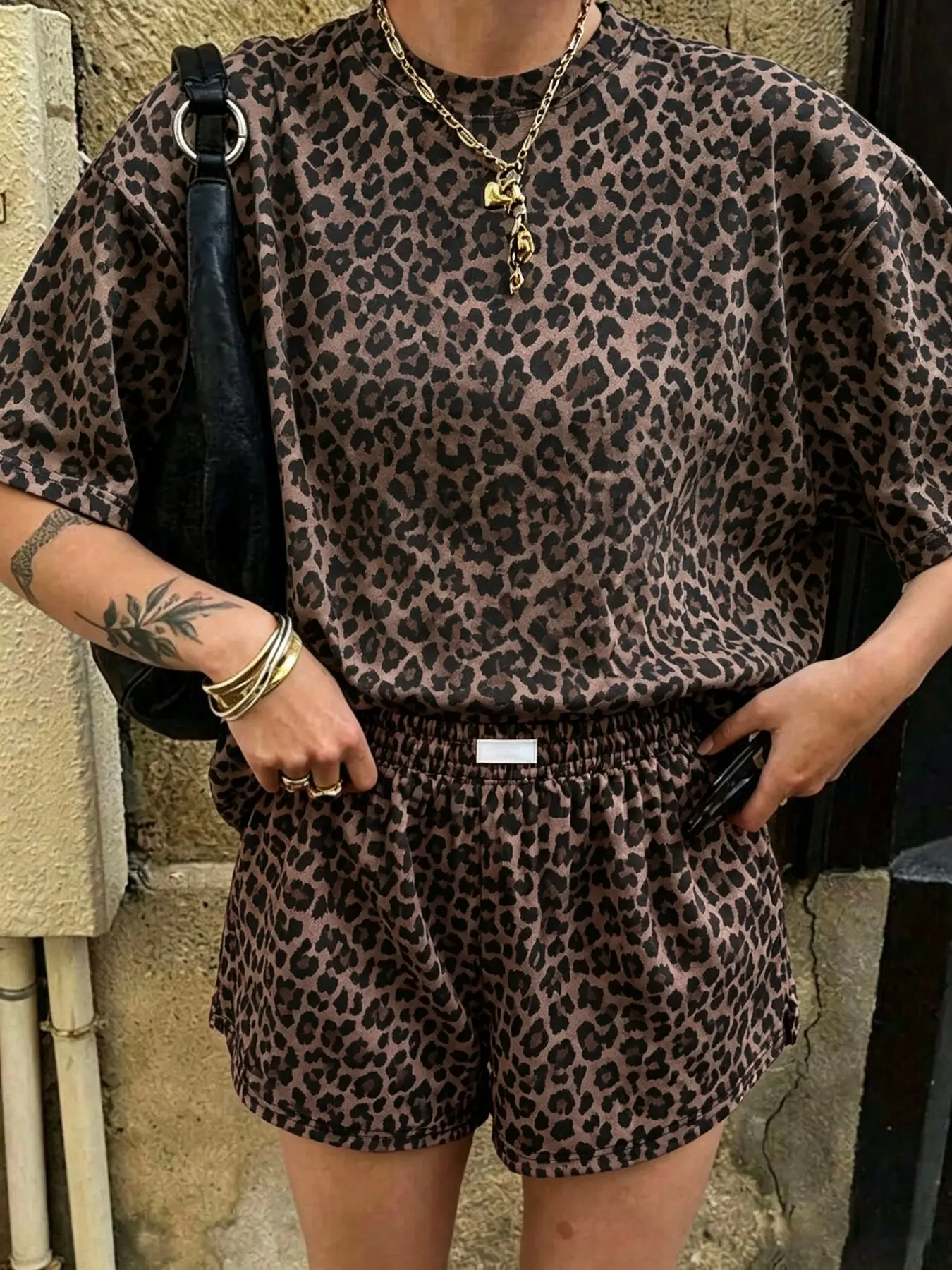 Chocolate brown leopard print two-piece women's set: loose short-sleeve T-shirt and elastic waist shorts with pockets, casual loungewear and activewear for summer, Y2K street style outfit.