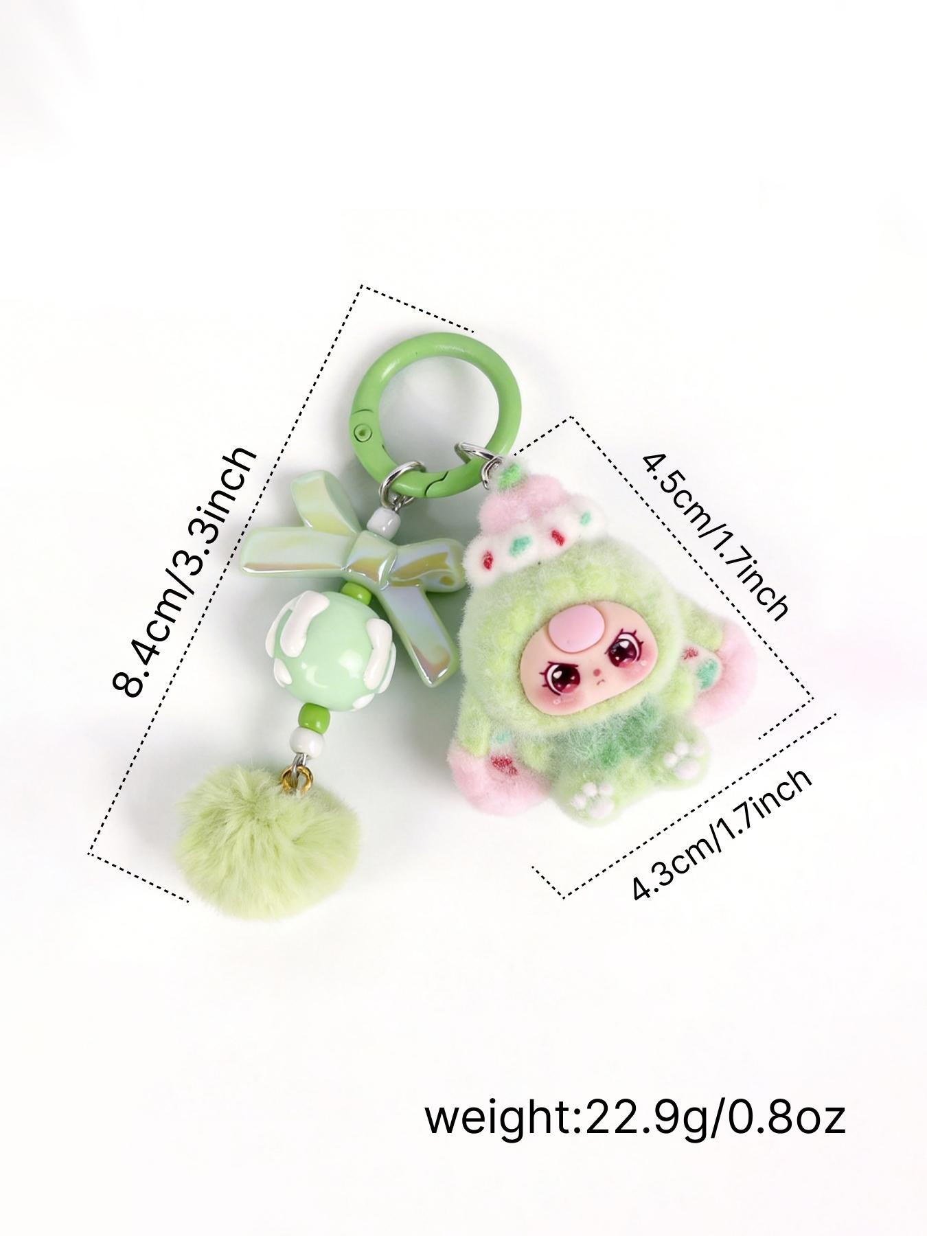A cute pendant featuring a multi-colored plush doll, paired with a bow ...