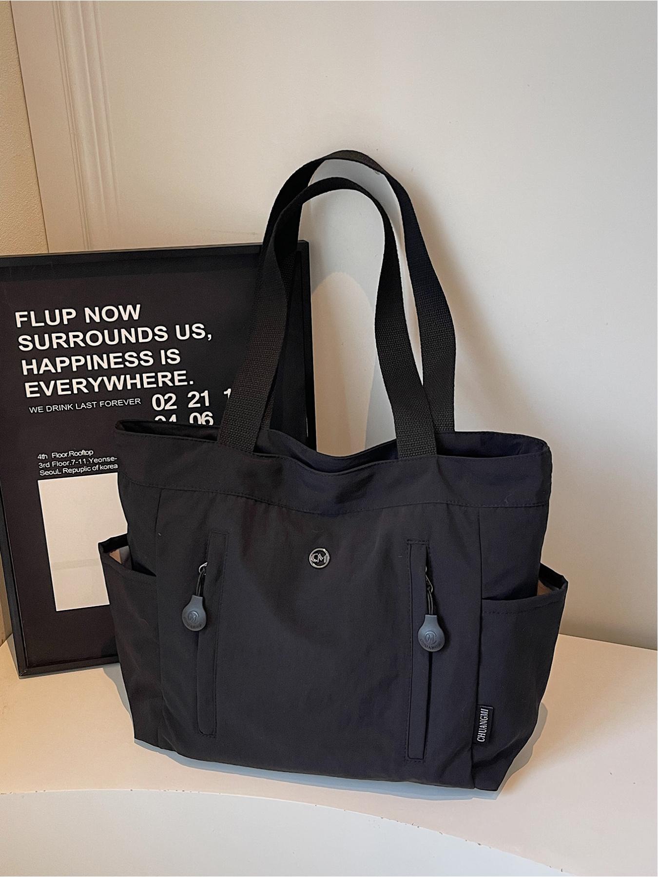 The large capacity soft commuter tote bag, is lightweight, spacious, suitable for daily use. It is a neutral waterproof nylon shoulder bag with a spacious interior suitable for 15 inch laptops, multiple side pockets, and a comfortable adjustab