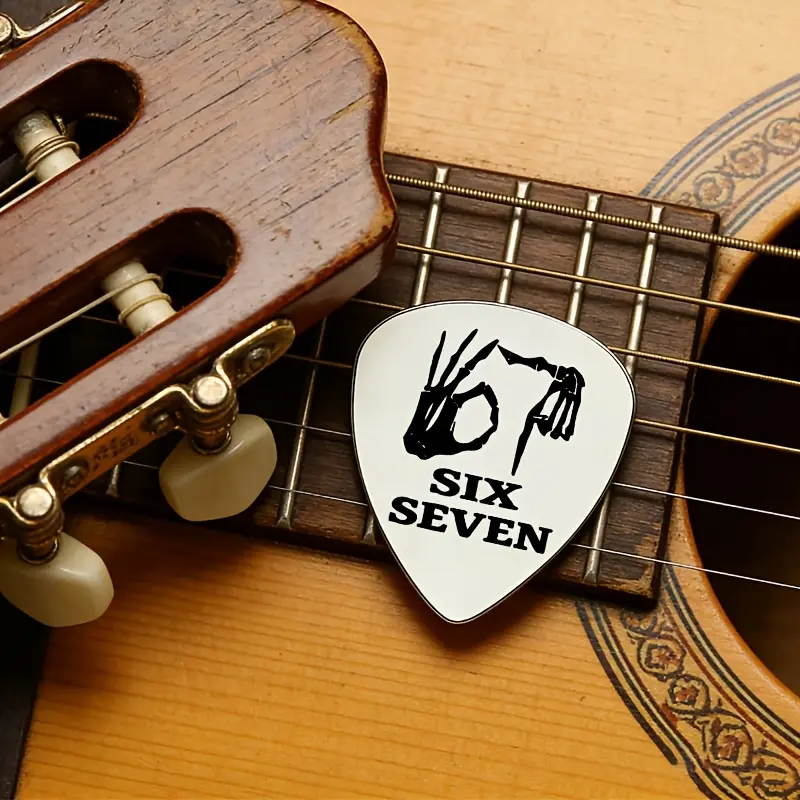 A "6/7" stainless steel guitar pick, designed with hardcore gestures, accurately hits rock and music lovers. It is a highly personalized instrument pick/trendy gift, perfectly suited to rock, punk and other music styles.