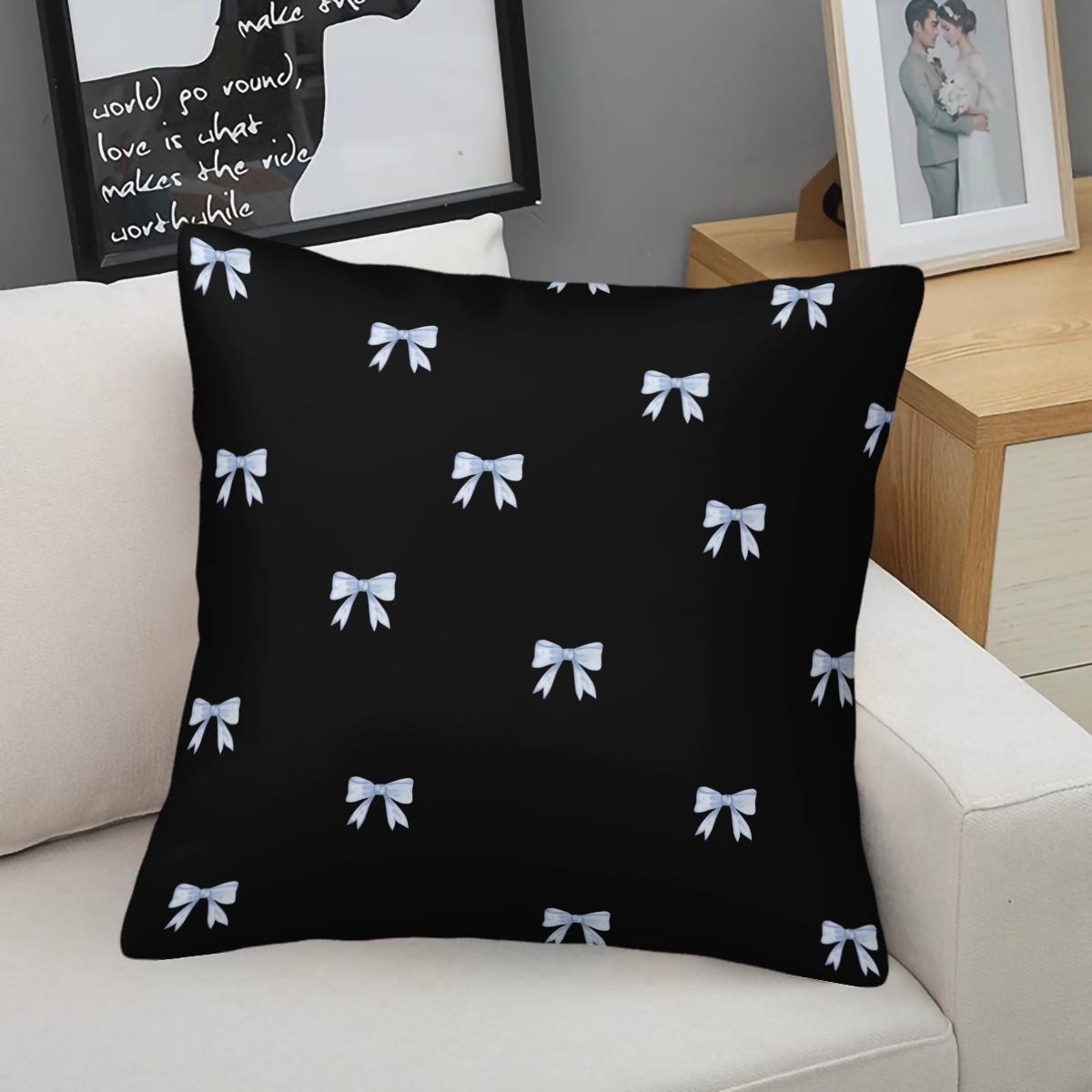 Soft short plush throw pillow with black background and blue bowknot print pattern, featuring a variety of patterns, soft and skin-friendly, a comfortable good for home or travel, embodying a lazy home style