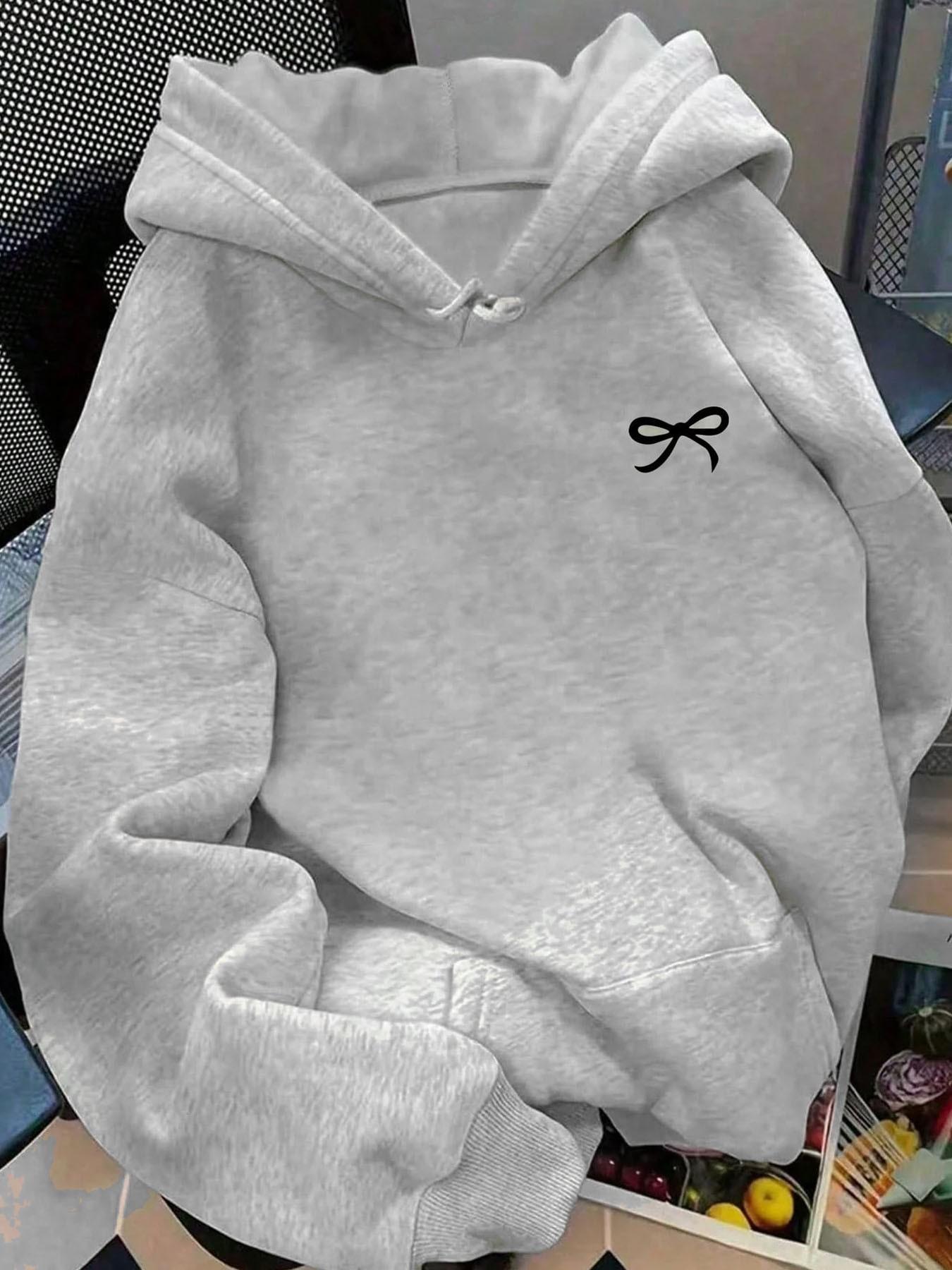 Soft fleece-lined, relaxed-fit graphic style with a bowknot, kangaroo pocket and adjustable drawstring hood. This on-trend hoodie sweatshirt pullover is perfect for versatile daily casual wear in fall and winter.
