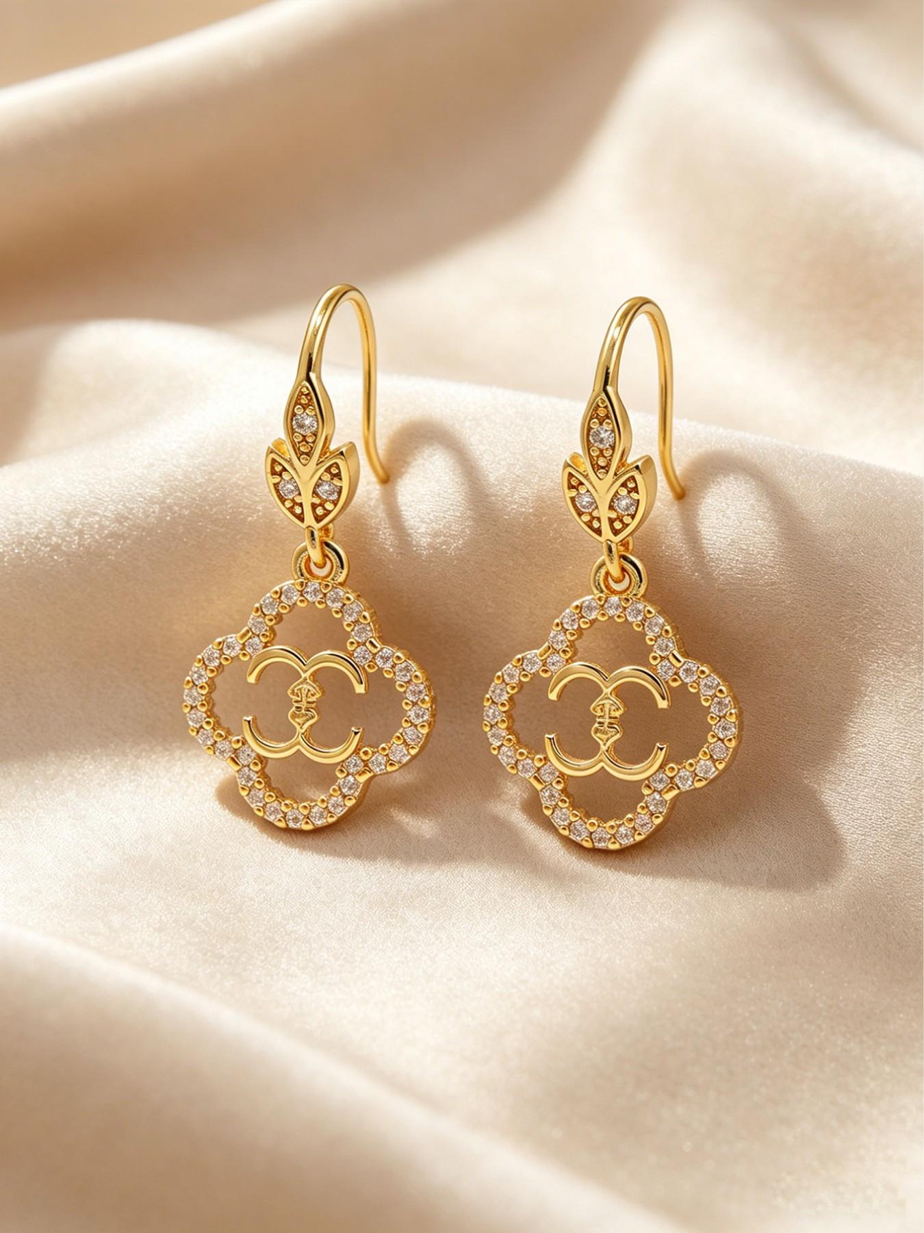 A pair of openwork flower earrings, delicate four-leaf clover earrings, and luxurious copper earrings inlaid with zircon