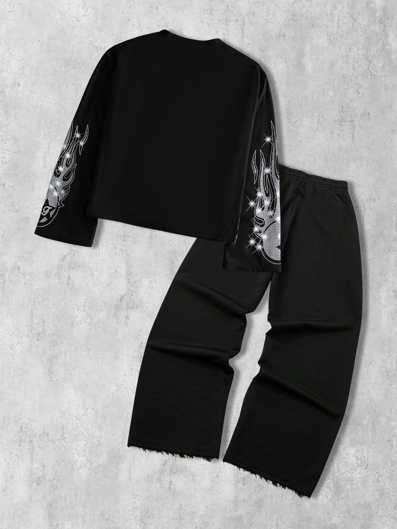 This men's two-piece set features a gothic streetwear design, including a long-sleeved T-shirt with a shimmering flame print and black flared trousers adorned with rhinestones and lettering.