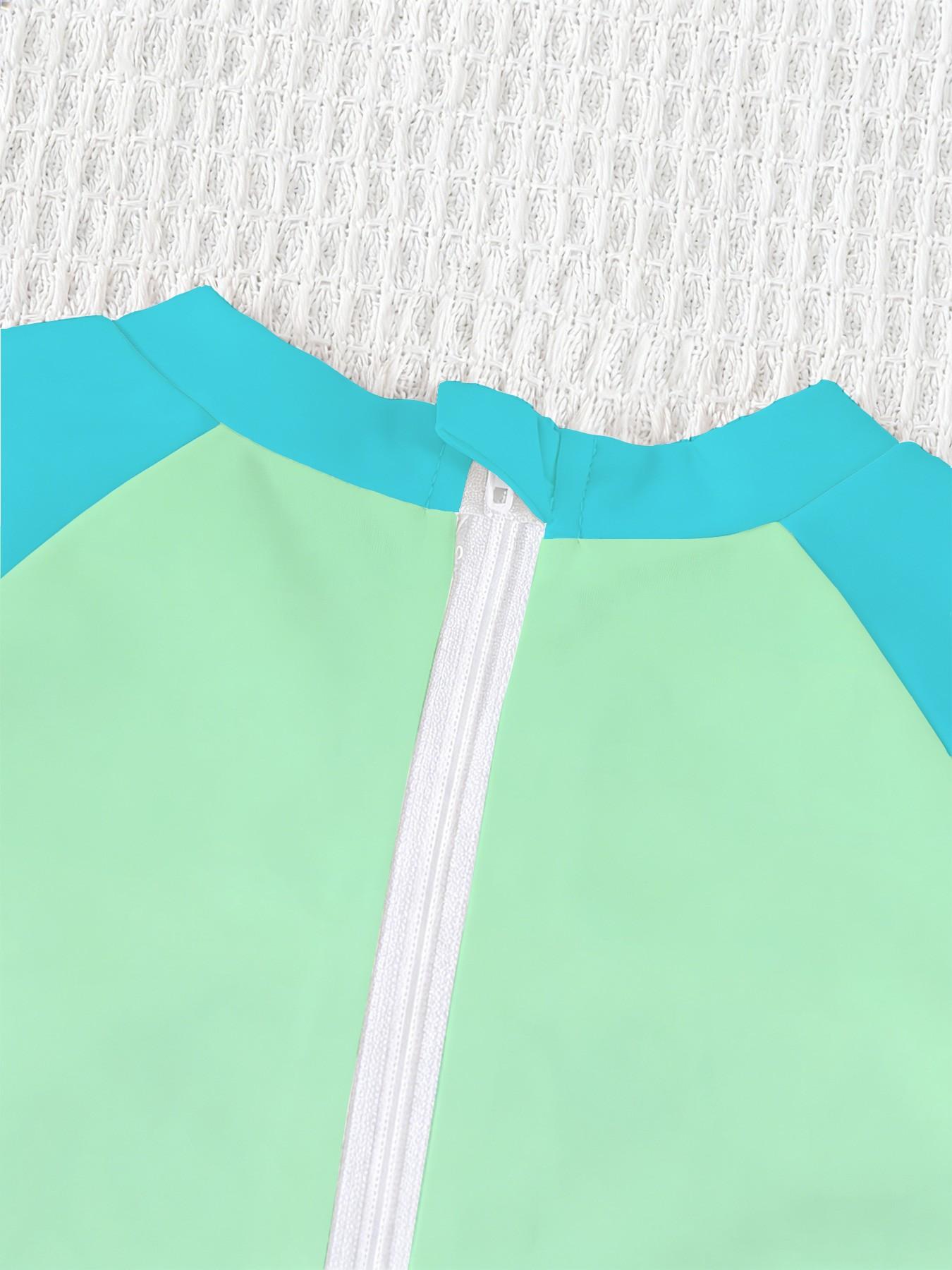 Boys' one-piece swimsuit "Ninja Turtles Breakthrough Screen Edition" features full vintage Ninja Turtles breakthrough screen print and raglan lake-blue sleeves. It is trendy, cool and sun-protective, eye-catching for summer water play and beach vacations.