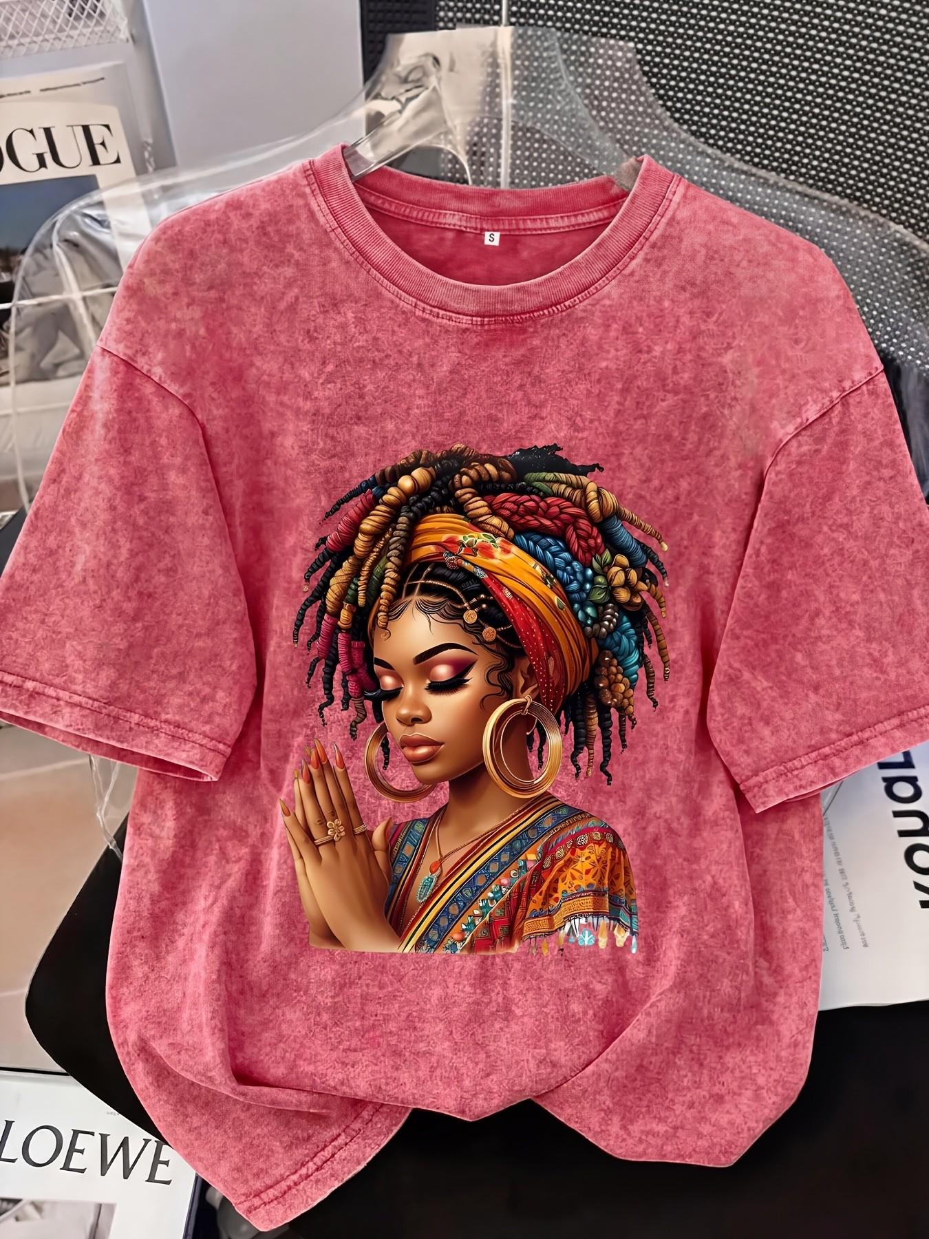 Distressed T-shirt featuring a colorful portrait print of an African woman; relaxed American style with soft, vintage-wash cotton fabric—perfect for pairing with denim shorts or wide-leg trousers for a casual street-style look Streetwear