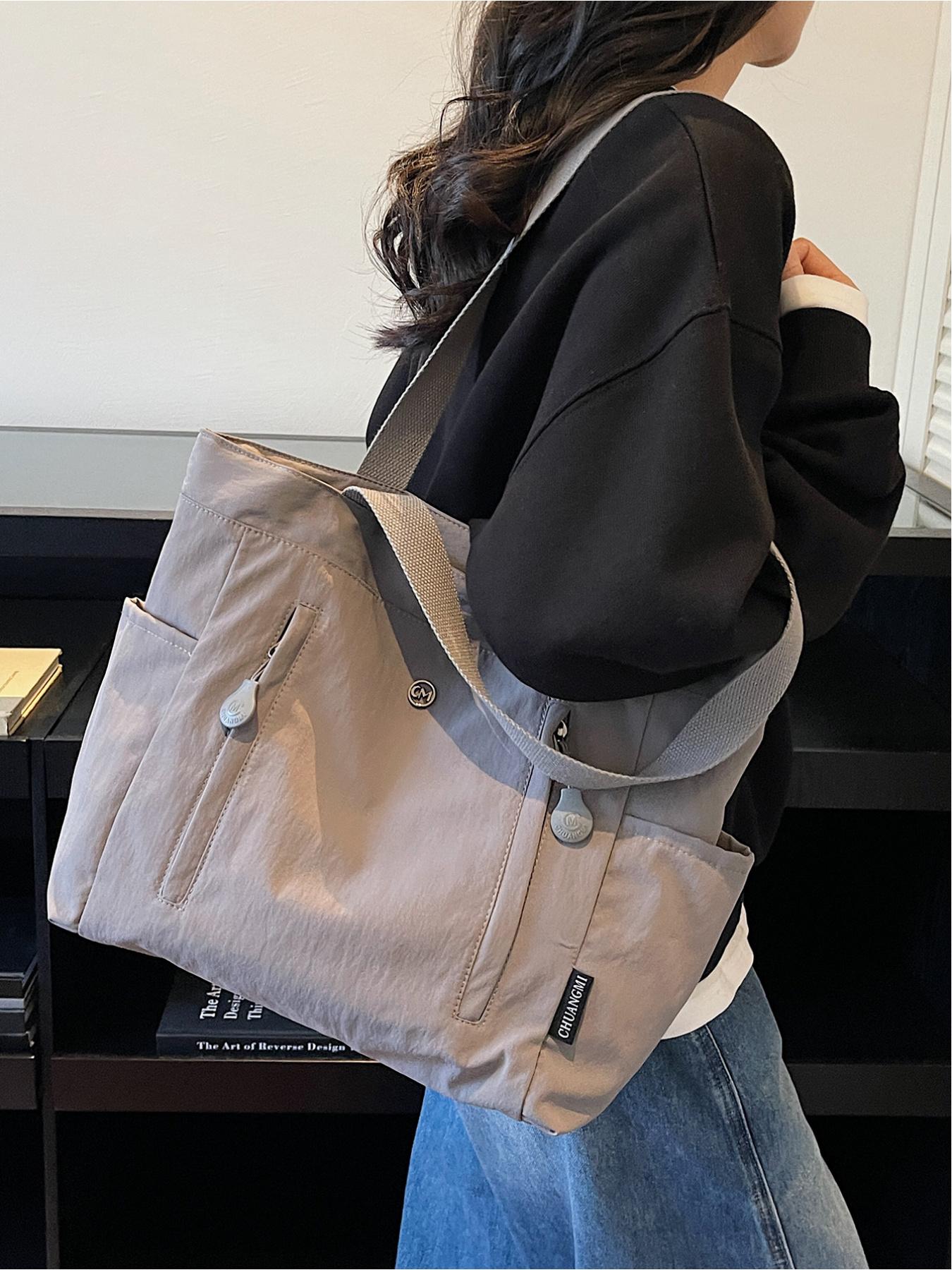 The large capacity soft commuter tote bag, is lightweight, spacious, suitable for daily use. It is a neutral waterproof nylon shoulder bag with a spacious interior suitable for 15 inch laptops, multiple side pockets, and a comfortable adjustab