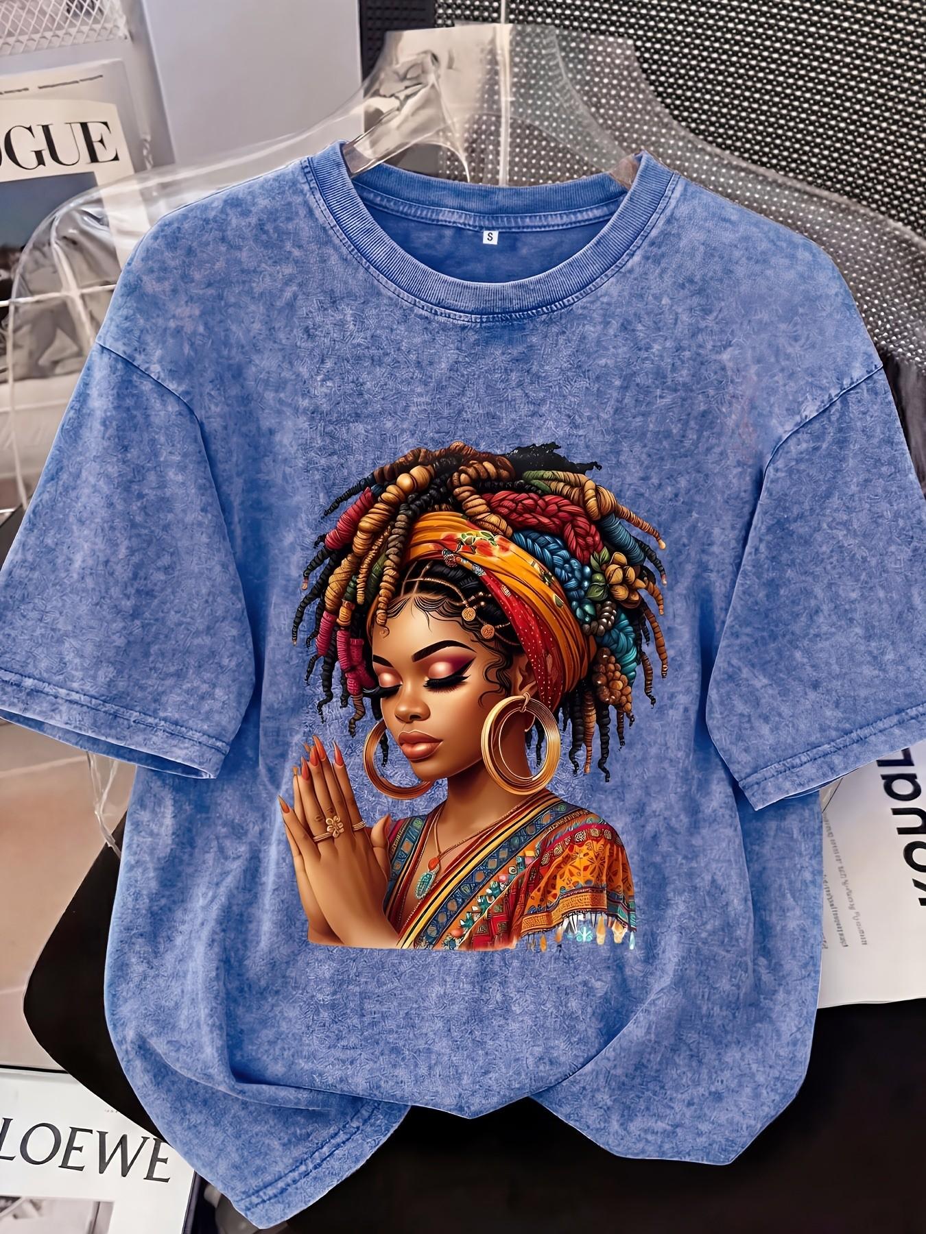 Distressed T-shirt featuring a colorful portrait print of an African woman; relaxed American style with soft, vintage-wash cotton fabric—perfect for pairing with denim shorts or wide-leg trousers for a casual street-style look Streetwear
