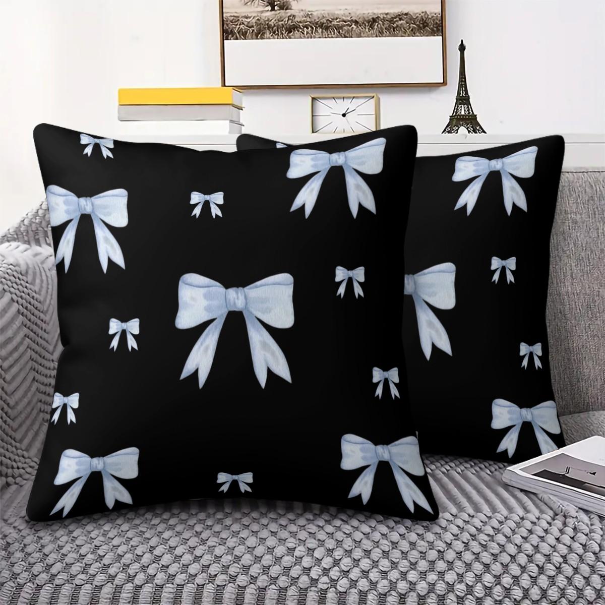 Soft short plush throw pillow with black background and blue bowknot print pattern, featuring a variety of patterns, soft and skin-friendly, a comfortable good for home or travel, embodying a lazy home style