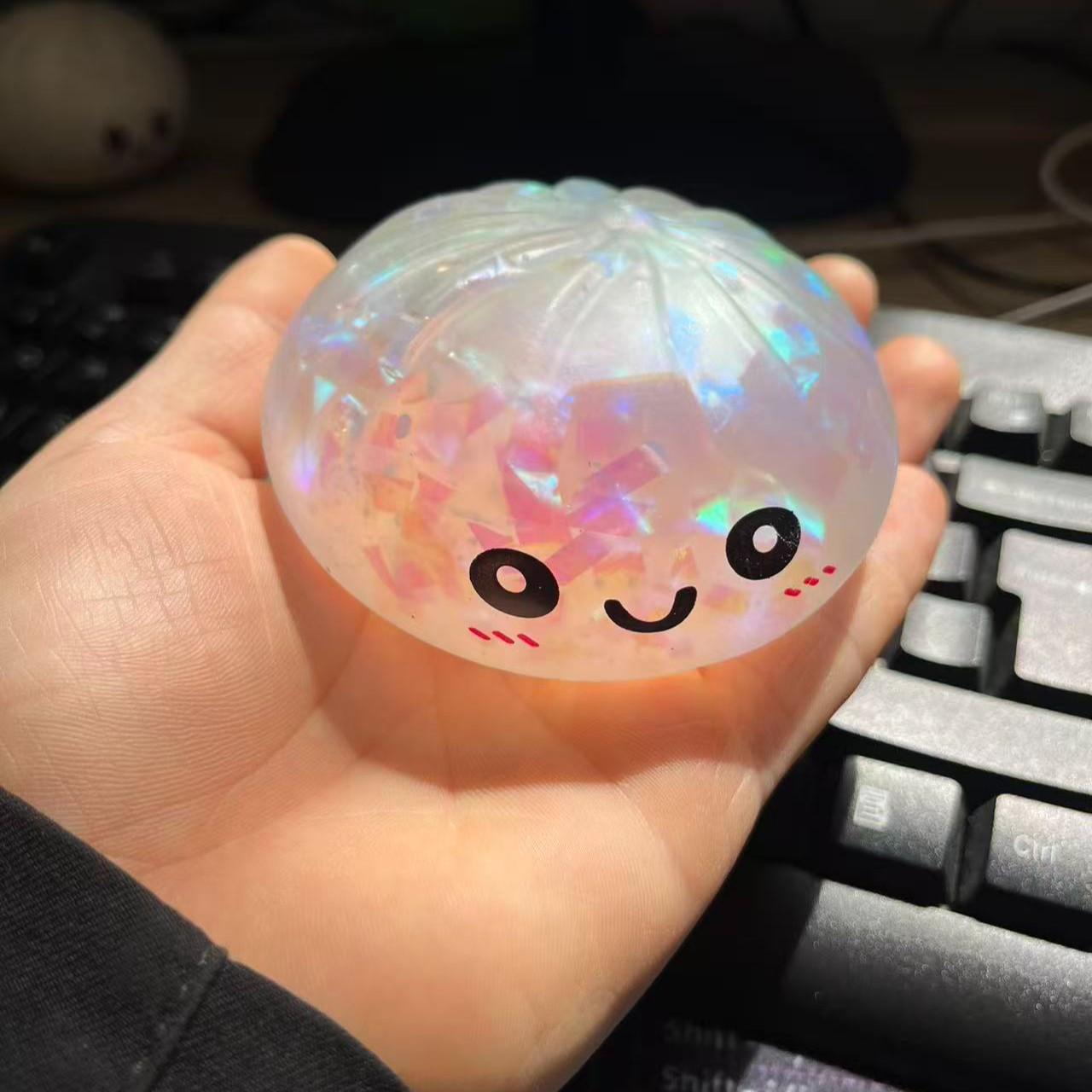 Cute Glitter Dumpling Stress Toy — a smiley-face squeezable sensory toy that’s fun for both kids and adults. Perfect for relaxation and desktop play, it also makes a great gift and a fun icebreaker for socializing and gatherings.