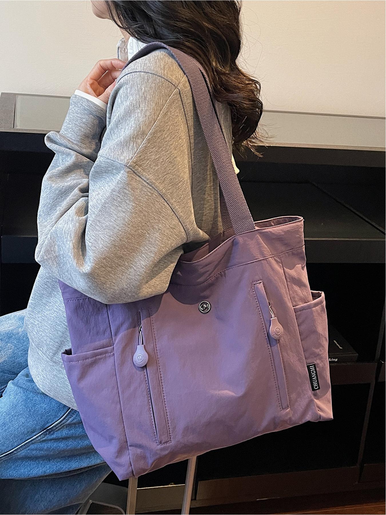 The large capacity soft commuter tote bag, is lightweight, spacious, suitable for daily use. It is a neutral waterproof nylon shoulder bag with a spacious interior suitable for 15 inch laptops, multiple side pockets, and a comfortable adjustab