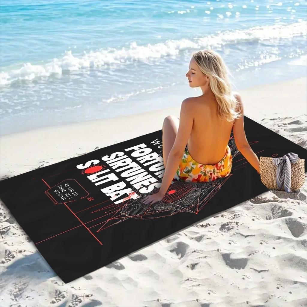 Black background with red geometric patterns and white text; beach towel/beach towel multi-functional use. Absorbent towel