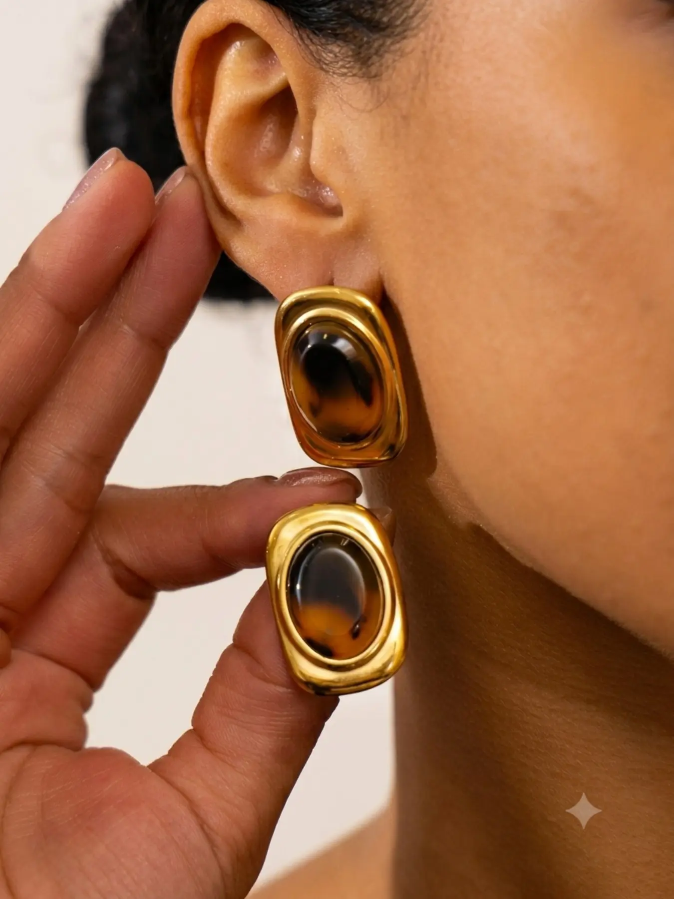 Geometric oval resin earrings featuring a unique, retro leopard-print design.